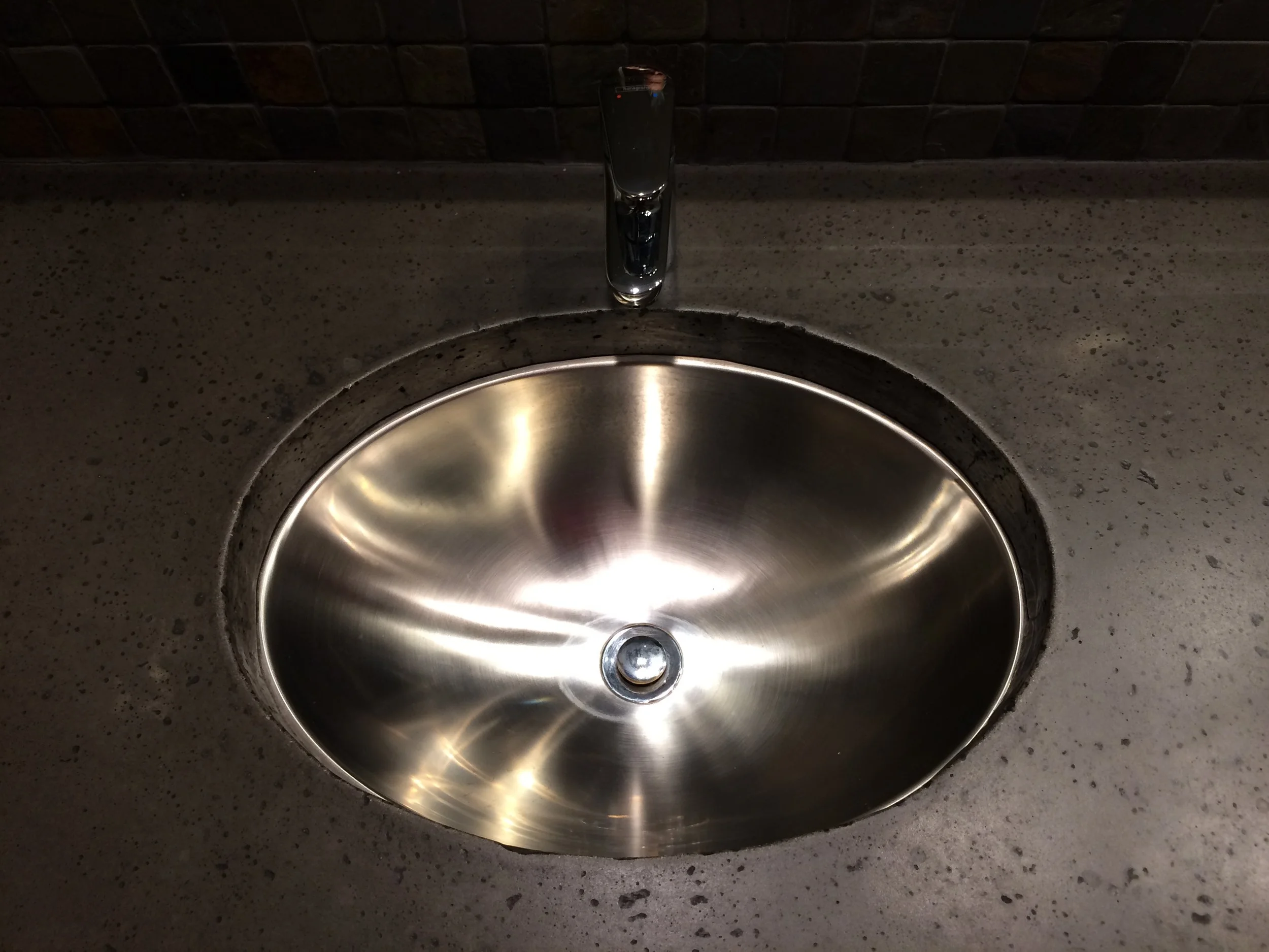 Industrial style concrete vanity with stainless steel undermount sink