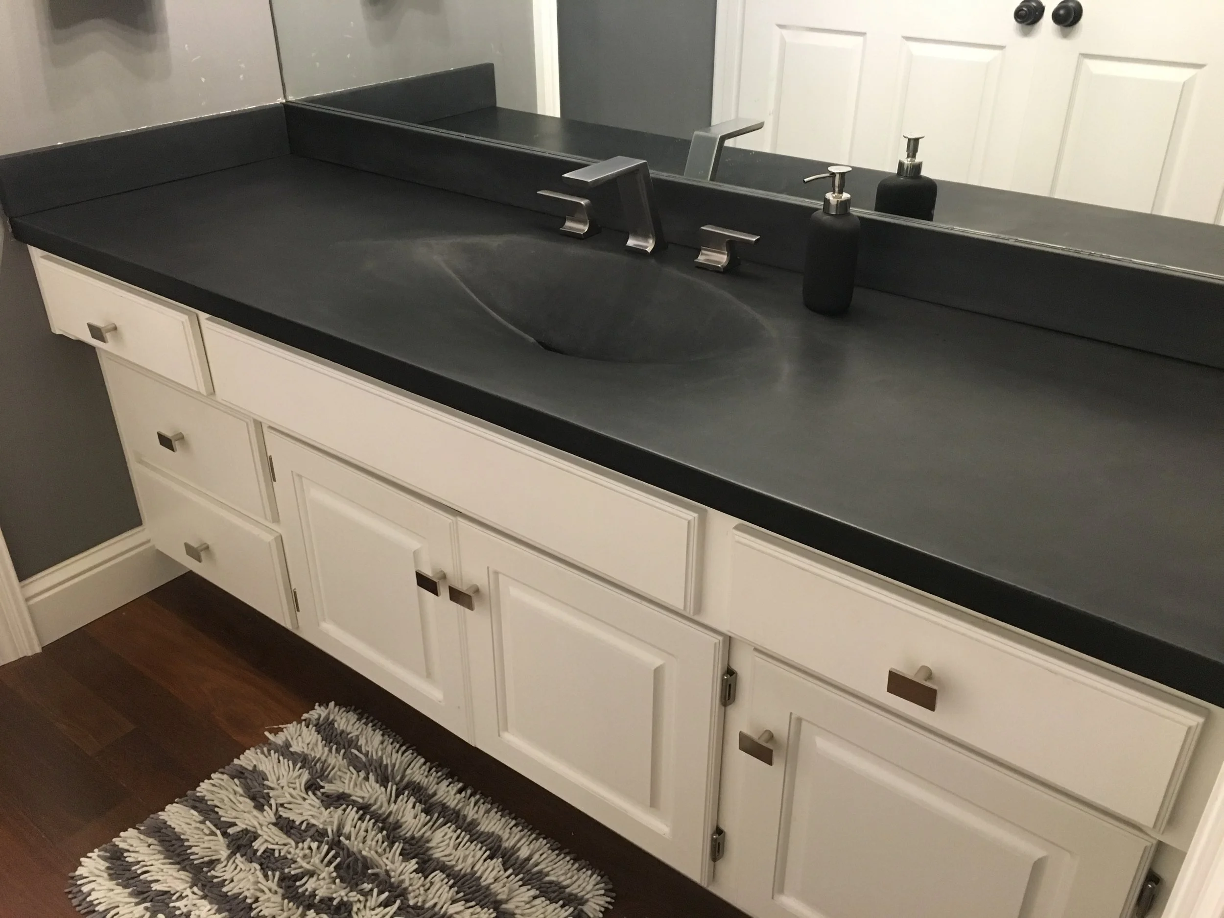 slot drain integrated sink vanity top in Onyx black finish with matching backsplash