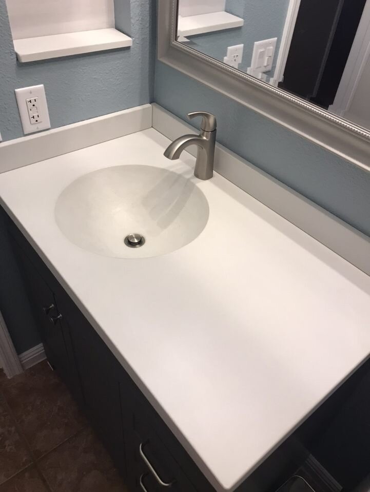 Alabaster vanity with integrated round sink and matching backsplash and wall shelf insert