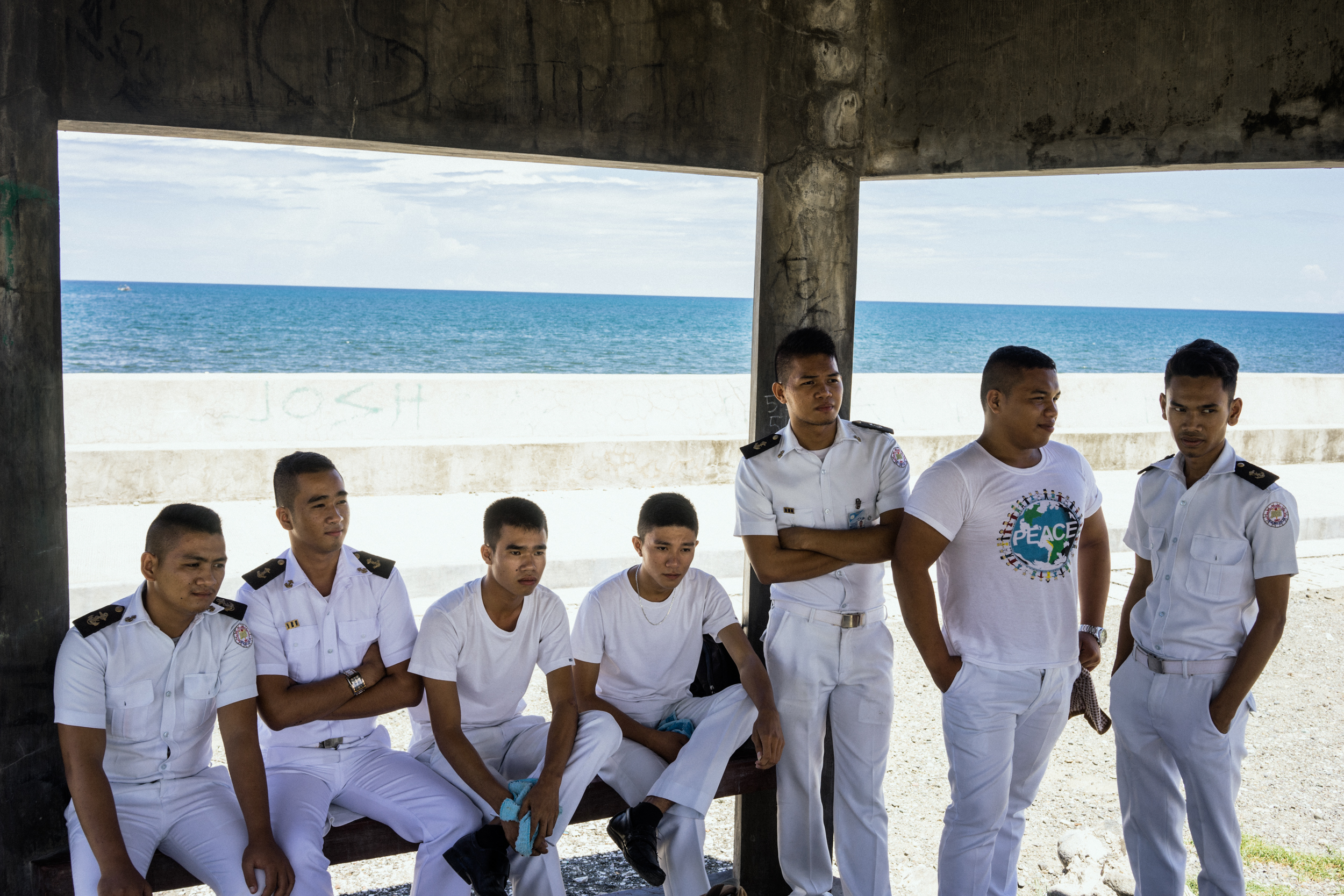  Kalibo, Philippines - September 21, 2015: Filipino students hang out near their maritime school. Seafaring is seen by many Filipino men as  a way out of poverty. Hannah Reyes 