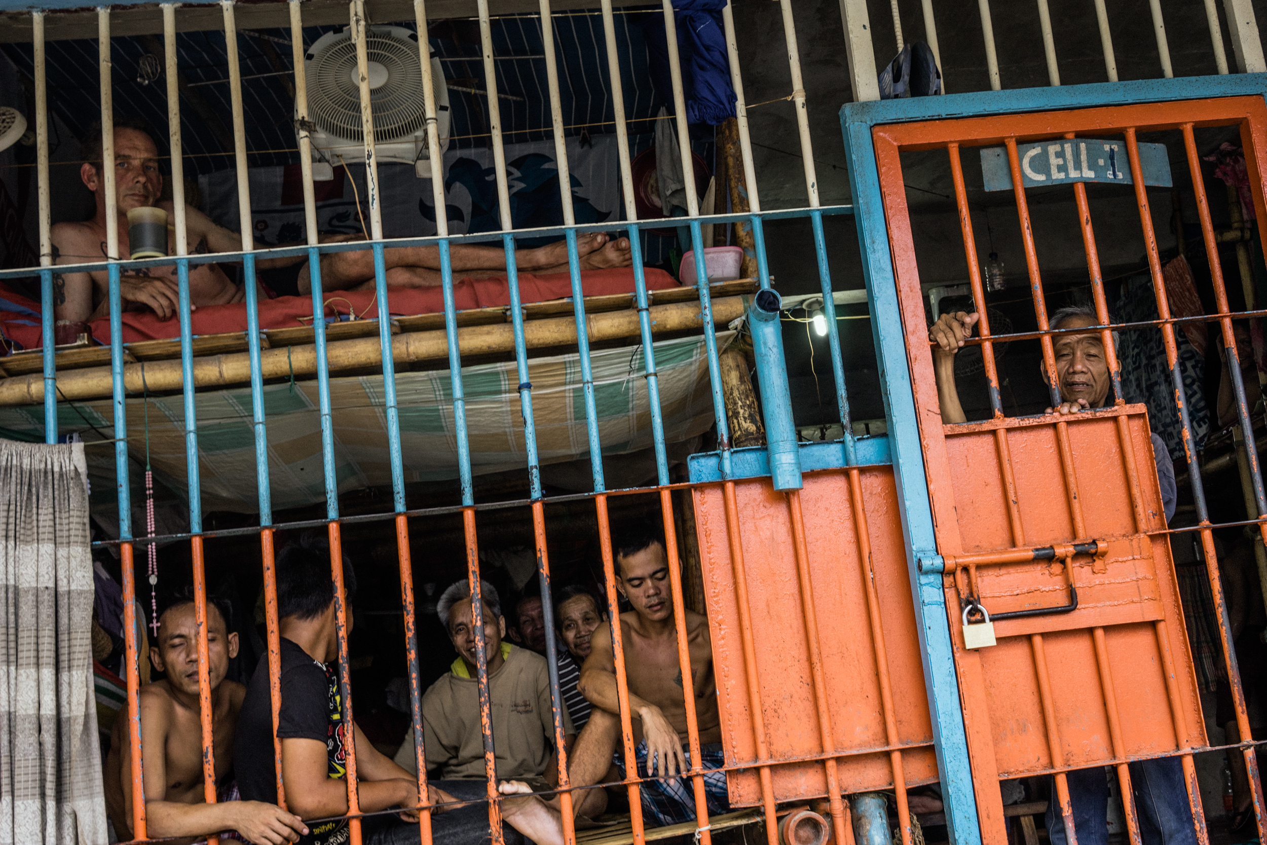  Kalibo, Philippines - September 20, 2015: Inmates at the local jail, where Celia Robelo, a Filipina woman, is being held for human trafficking and illegal recruitment charges following the death of a Filipino seafarer. Robelo claims that she did not