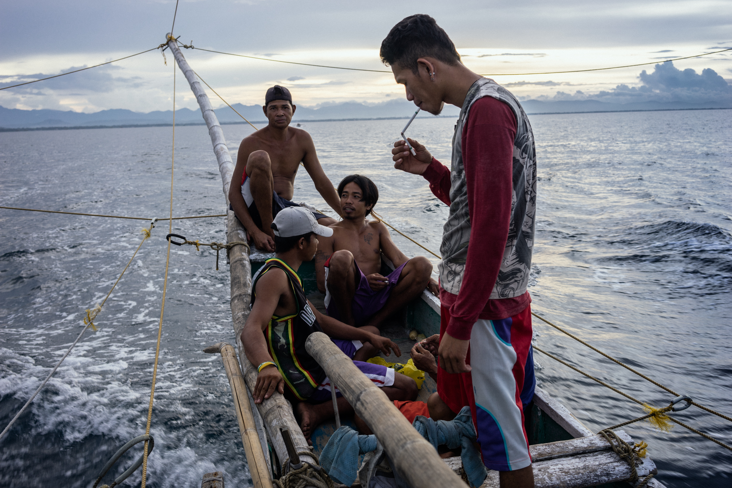  Kalibo, Philippines - September 21, 2015: The crew of a local fishing boat heads out for their night's catch. Members of the crew, who make approximately 35 USD per month, have expressed their desire to work on a larger fishing vessel for the promis
