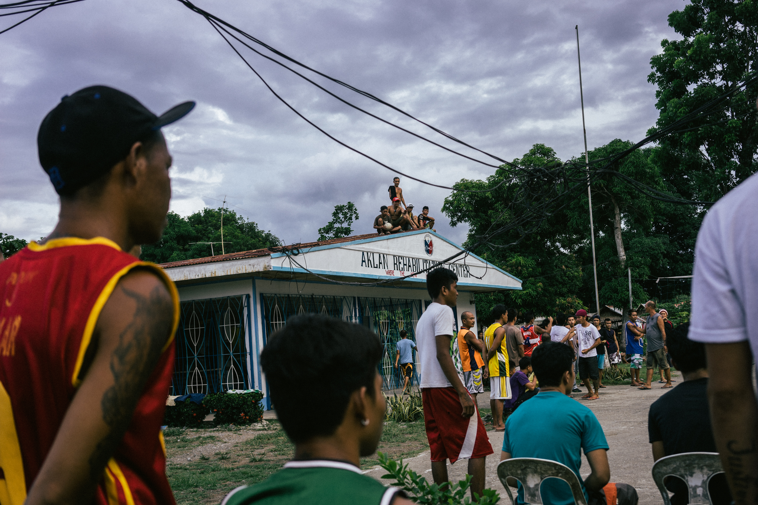  Kalibo, Philippines - September 20, 2015: Men are seen at a local jail. The jail is now home to Celia Robelo, who is being charged for human trafficking and illegal recruitment, following the death of a Filipino seafarer. Robelo claims that she did 