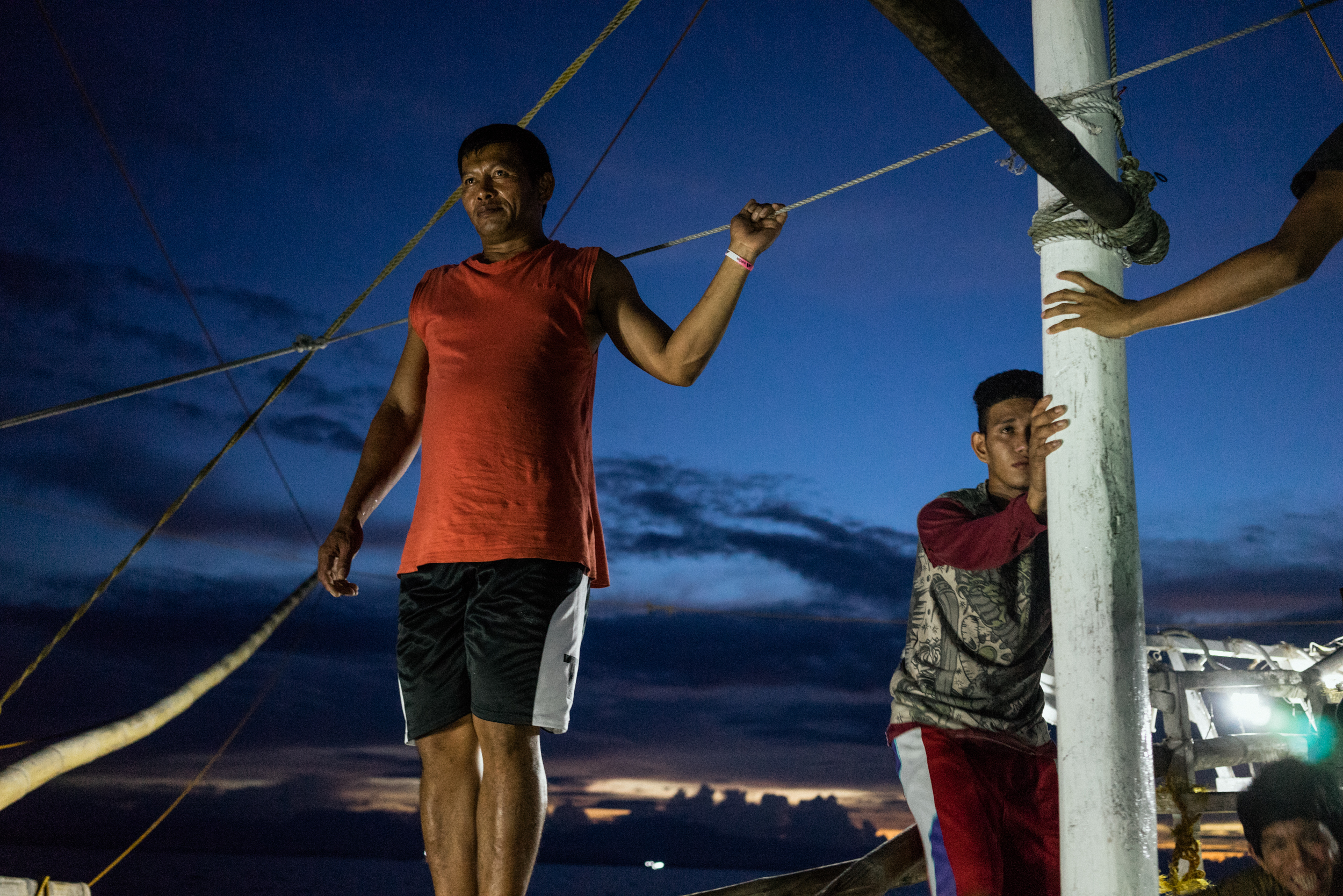  Kalibo, Philippines - September 21, 2015: The captain of a local fishing boat is seen at work. Members of the crew, who make approximately 35 USD per month, have expressed their desire to work on a larger fishing vessel for the promise of a higher i