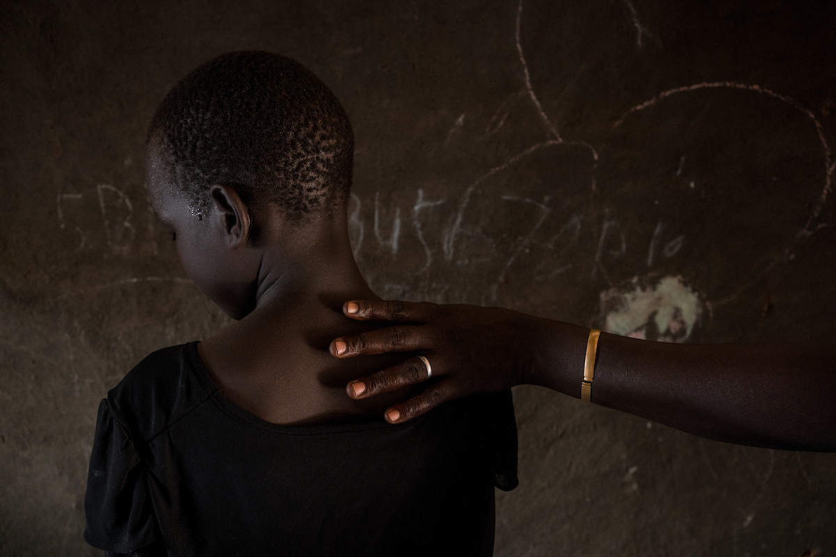 A young girl, who witnessed her mother being raped when they were collecting firewood, is seen in her home in a POC site in South Sudan. In South Sudan, women and girls displaced from war must leave protection of civilians sites to collect firewood - a task traditionally done by women, who make up majority of the population in these camps. The journey is perilous and puts these women at continued risk of sexual violence, which rights groups have called an 'epidemic' in the country.