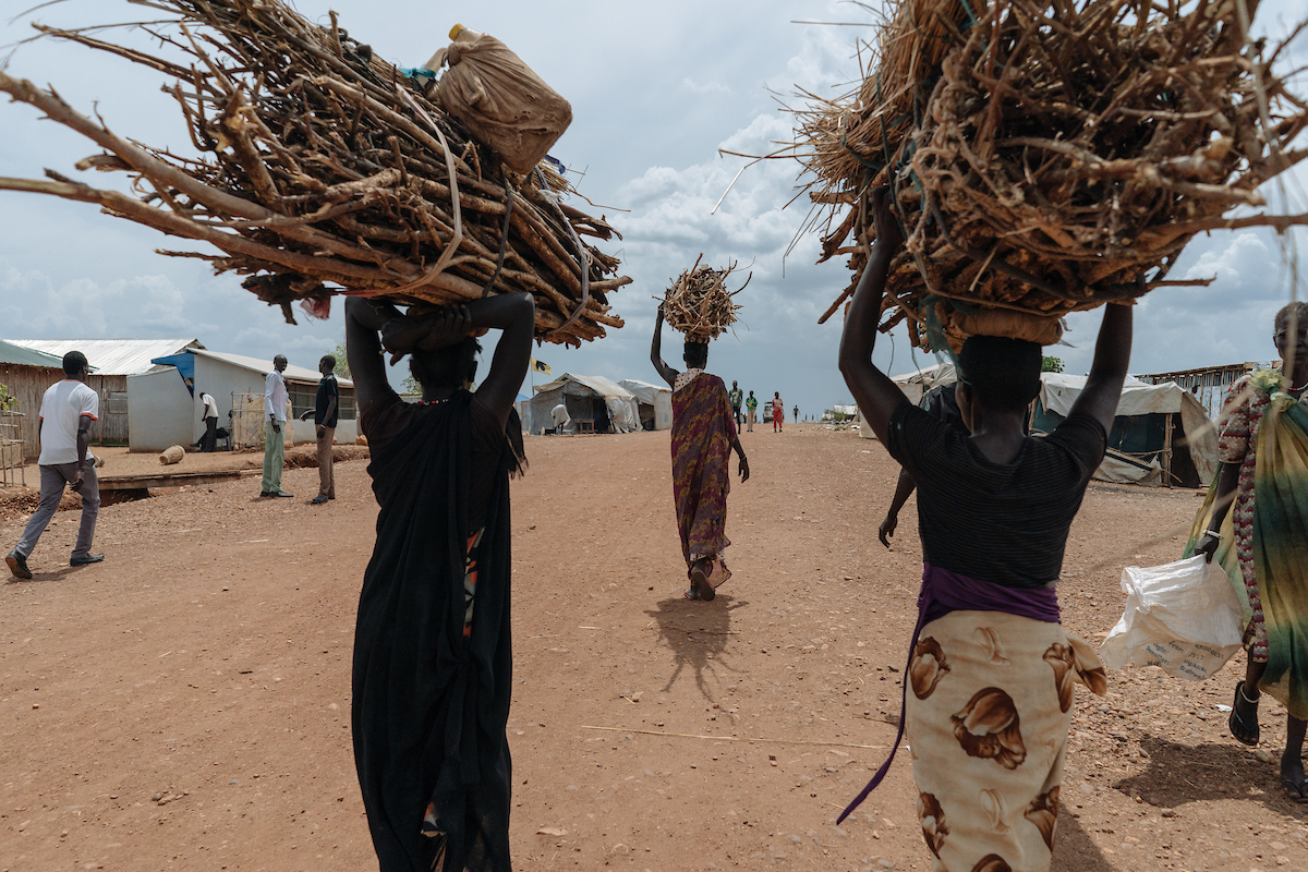 After collecting firewood, women return home in groups to protect themselves from being an easy target for rapists. In South Sudan, women and girls displaced from war must leave protection of civilians sites to collect firewood - a task traditionally done by women, who make up majority of the population in these camps. The journey is perilous and puts these women at continued risk of sexual violence, which rights groups have called an 'epidemic' in the country.
