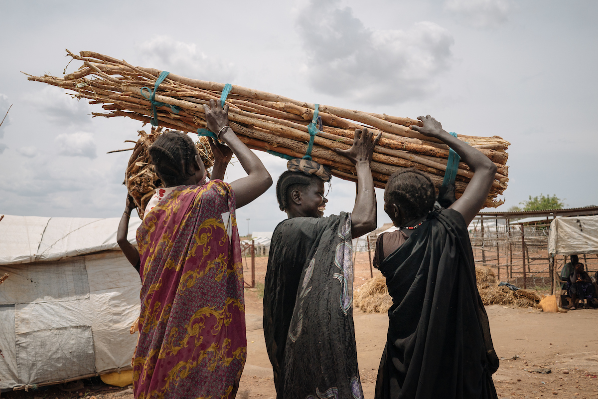 Women help each other carry firewood in Juba, South Sudan. In South Sudan, women and girls displaced from war must leave protection of civilians sites to collect firewood - a task traditionally done by women, who make up majority of the population in these camps. The journey is perilous and puts these women at continued risk of sexual violence, which rights groups have called an 'epidemic' in the country.