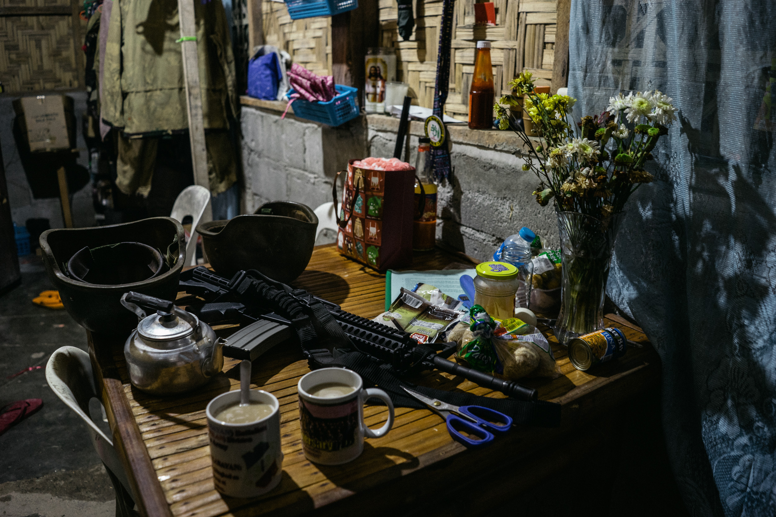  A gun is seen on the table of an Armed Forces of the Philippines (AFP) battalion's ladies' barracks, beside flowers from an officer's boyfriend. 