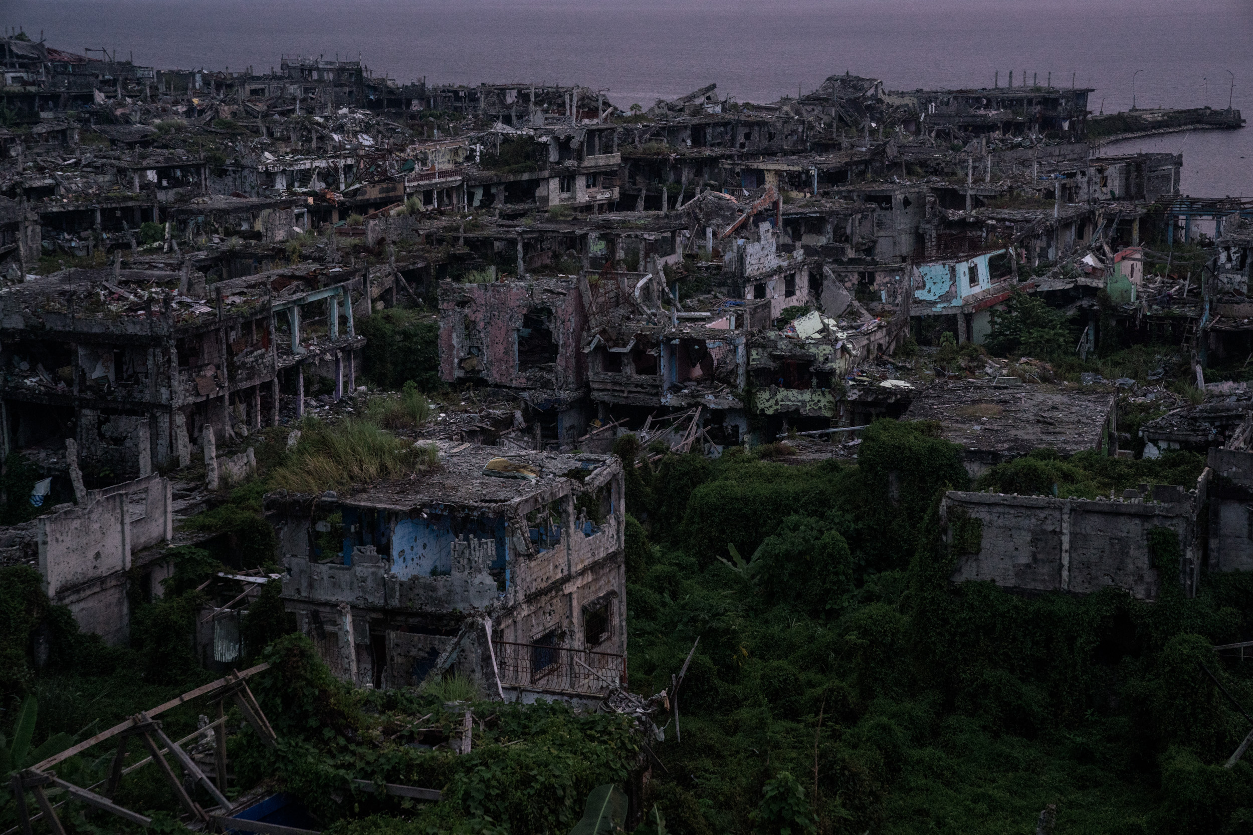  Destroyed buildings in the main battle area of the Marawi siege are seen during sunset, still damaged more than a year since the Philippine military declared the Muslim-majority city of Marawi “liberated” from ISIS-linked militants. But the ravaged 
