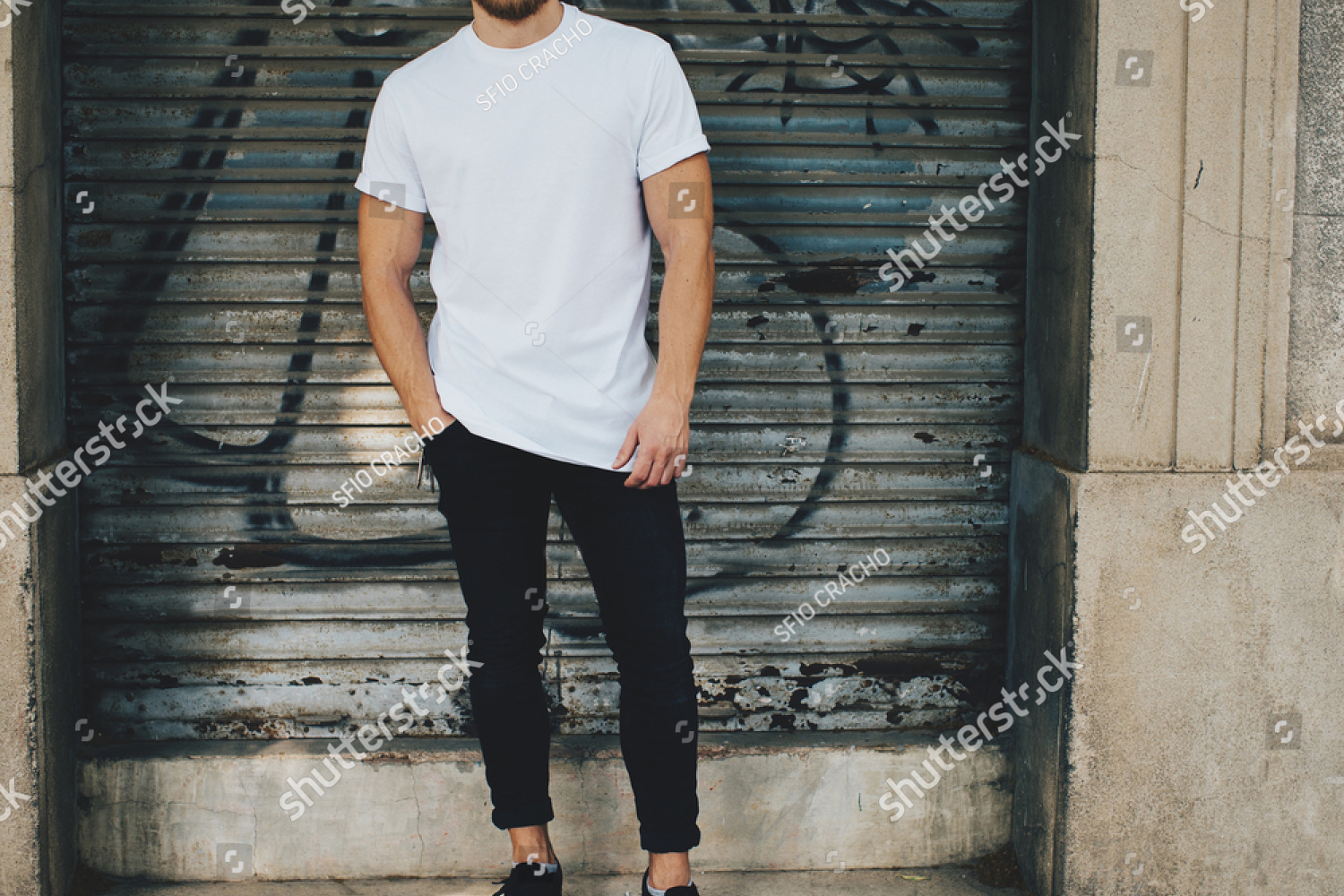 stock-photo-bearded-guy-wearing-white-blank-t-shirt-and-black-jeans-standing-opposite-garage-377318167.jpg