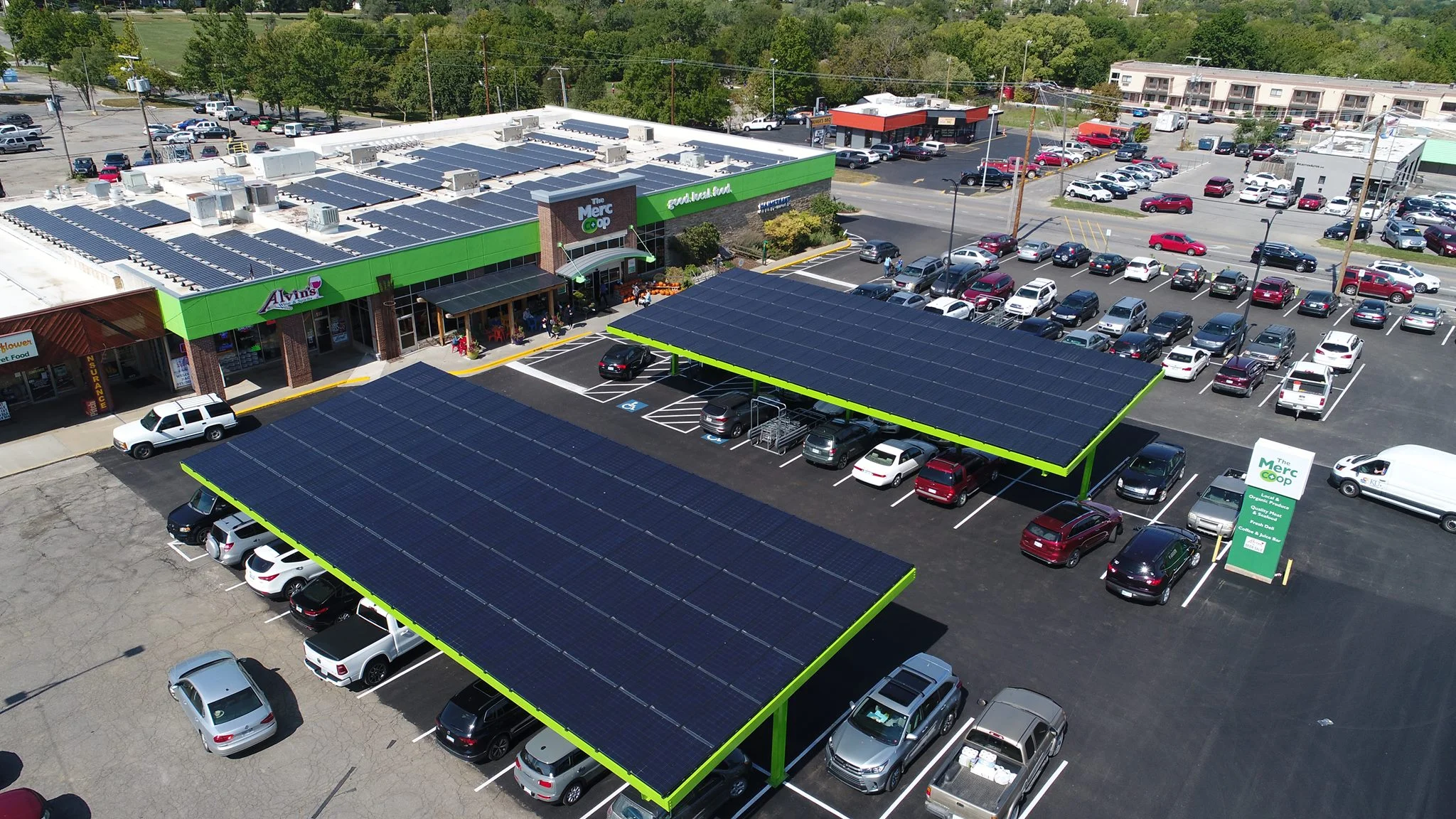 Cromwell Solar installation crew place a panel on a roof.