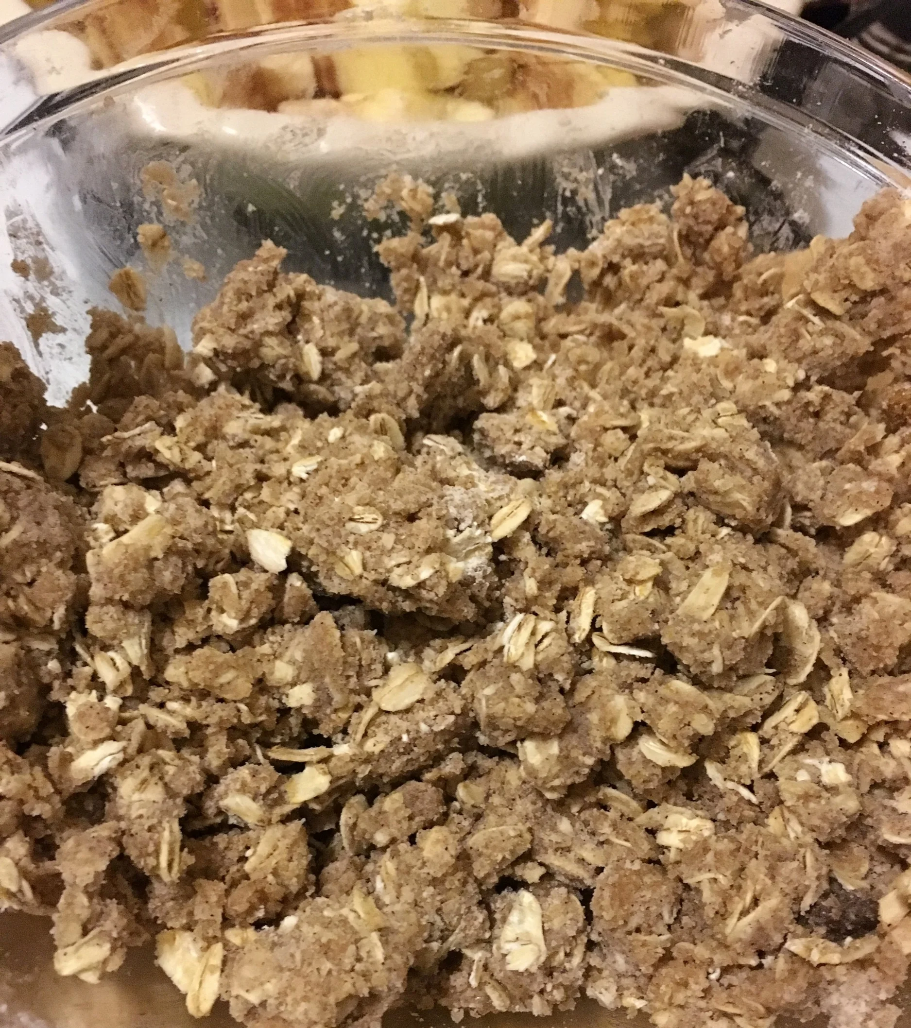 Drizzle your softened/melted butter into your dry ingredients. Get your hands dirty because that's the best way to make these crumbs! Don't use a spoon or fork because it'll just annoy the hell out of you. Scrunch all of the ingredients together with your hands until they have this consistency and will stay stuck together a bit when you squeeze it. You may have to add all of the butter or a bit less depending on your flour and stuff so just eye ball it until it looks like this. 