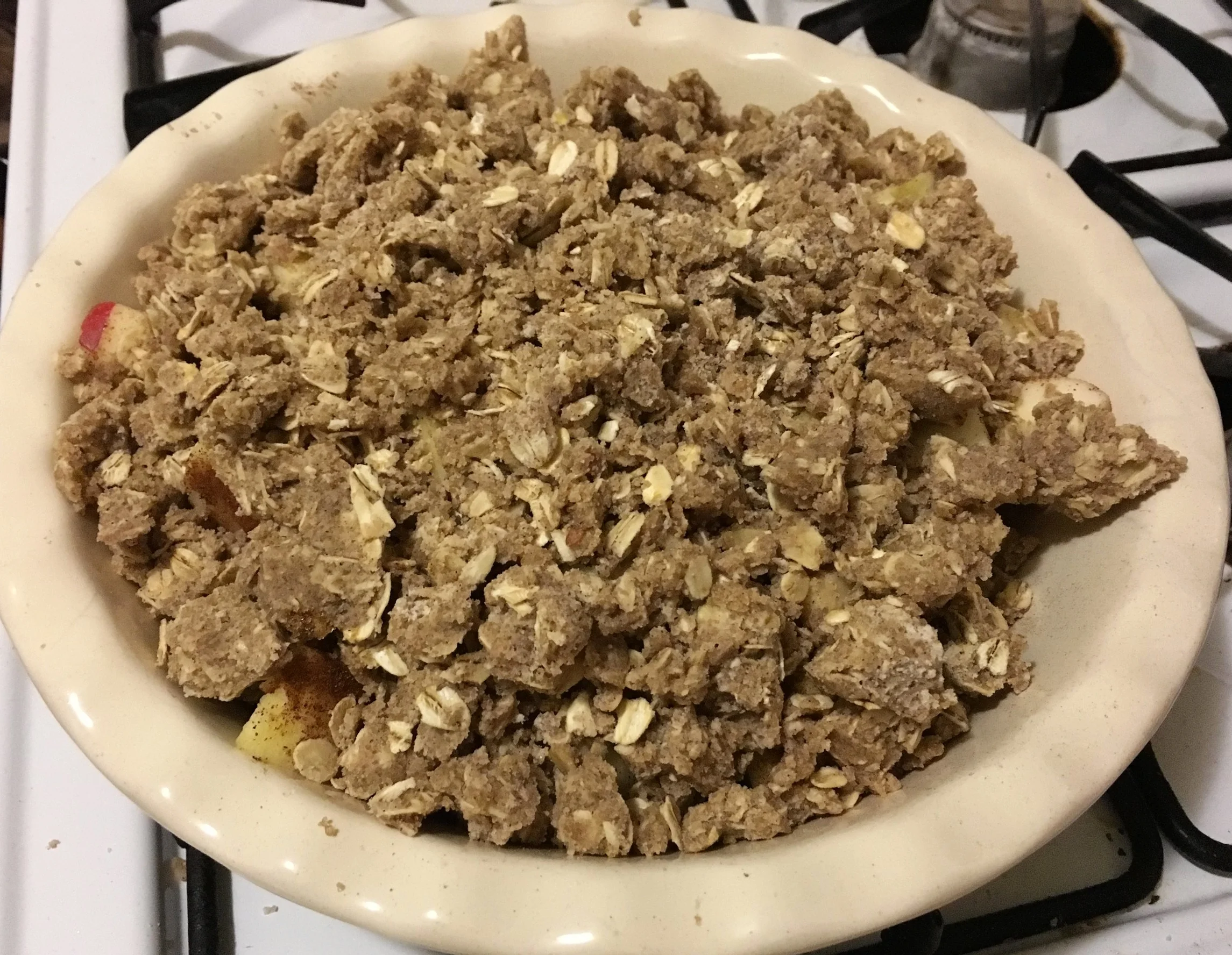 Disperse the crumbs on top of your apples. Leave some bigger chunks of crumb mixture because that will be a nice surprise when you go to eat it later! It's like a chunk of cookie on top of your apples :) SOooooo good Cook in your preheated 350 degree oven for about 40-45 minutes until the crumbs are browned and crisp-y (haha, get it? apple CRISP) and your apples are soft to the touch. I put a scoop of some coconut milk ice cream that I happened to have which was so yummy. It was strawberry ice cream, that's why it looks pink in the picture, but regular vanilla ice cream or coconut whipped cream is amazing on this as well. I hope you enjoy it as much as I do and make it just as frequently!! It can be a simple cozy night in kind of dessert or can be made fancier for dinner parties by baking them in individual little ceramic bowls. Whatever floats your boat.