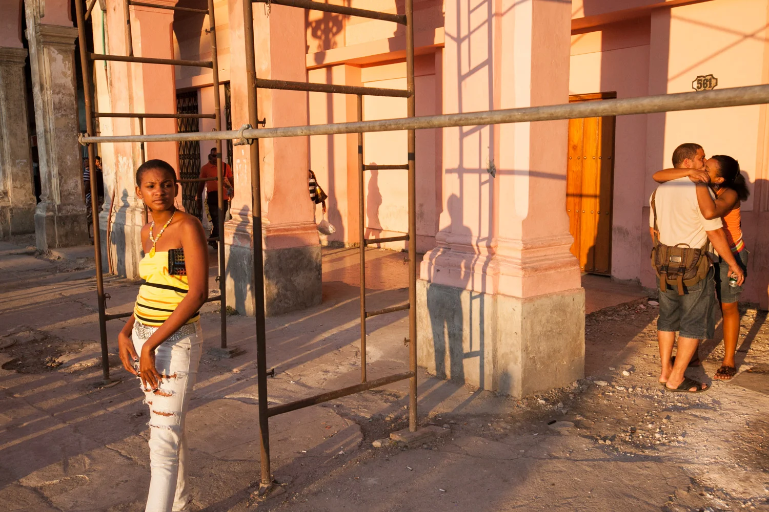 Locals and lovers pass the time at a bus stop in the heart of Havana.