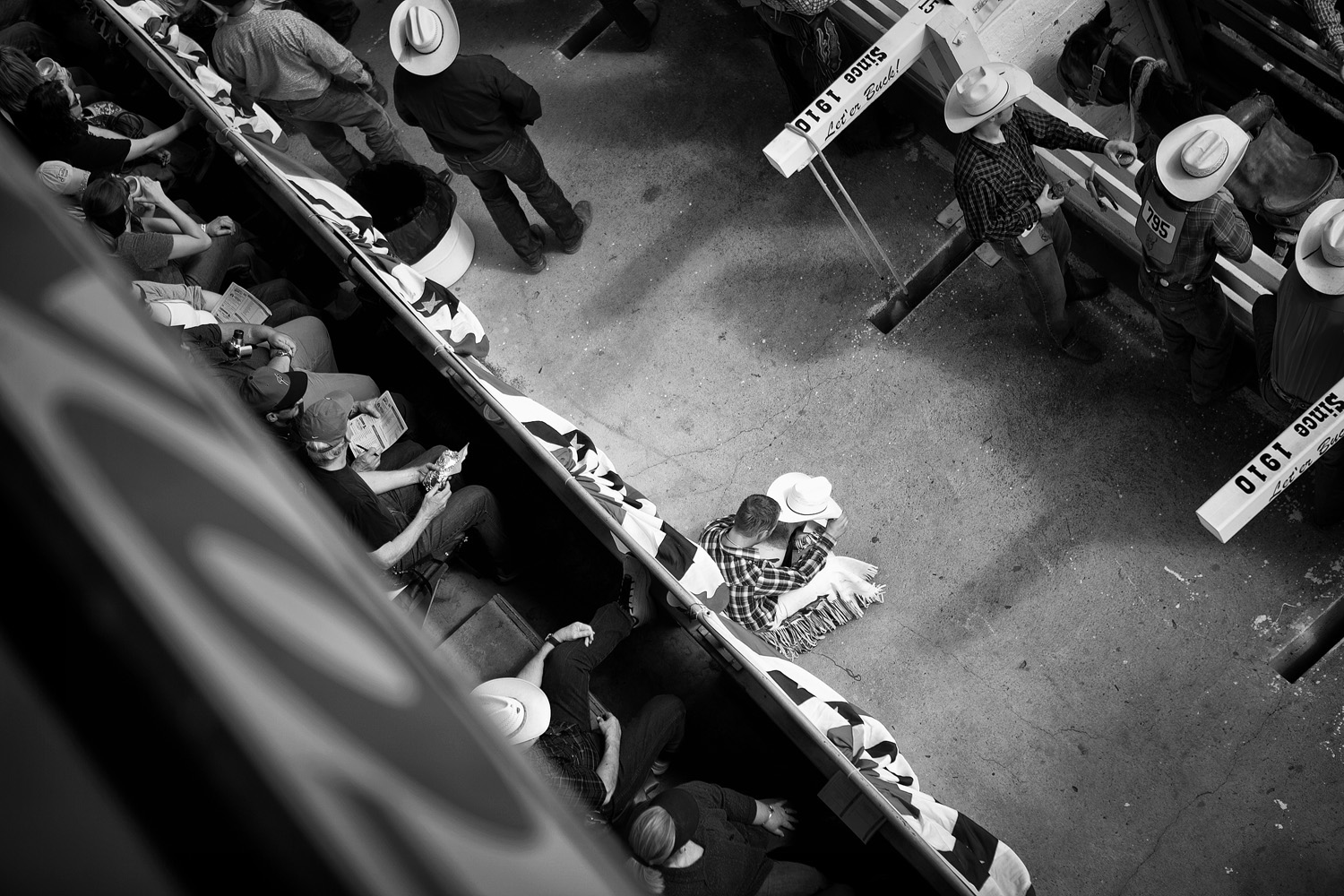 Most rodeo events are designed for individual participants. Therefore, with the goal of winning prize money, a cowboy may spend the majority of the year on the road traveling to numerous competitions. One competitor takes a solitary moment of prayer before a rough stock event.