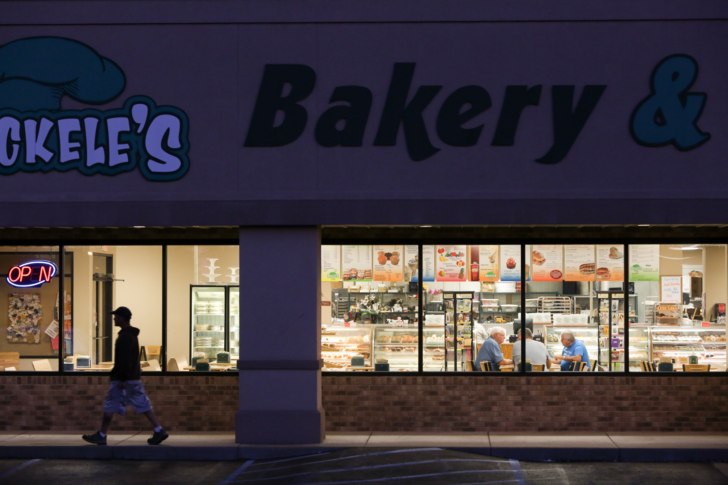  A patron exits the Hoeckele’s bakery, an establishment that has been in operation since 1937. The bakery opens at 3:00AM – typically to a line of faithful patrons. 