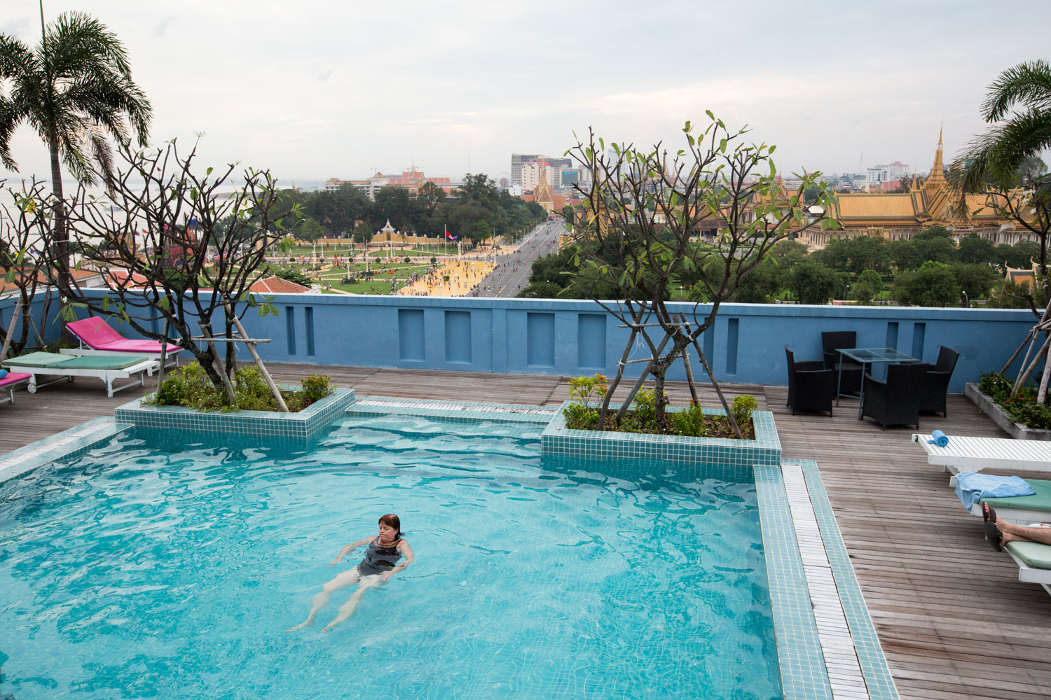A patron at the Frangipani Royal Palace Hotel in Phnom Pehn, Cambodia, relaxes in a rooftop swimming pool.