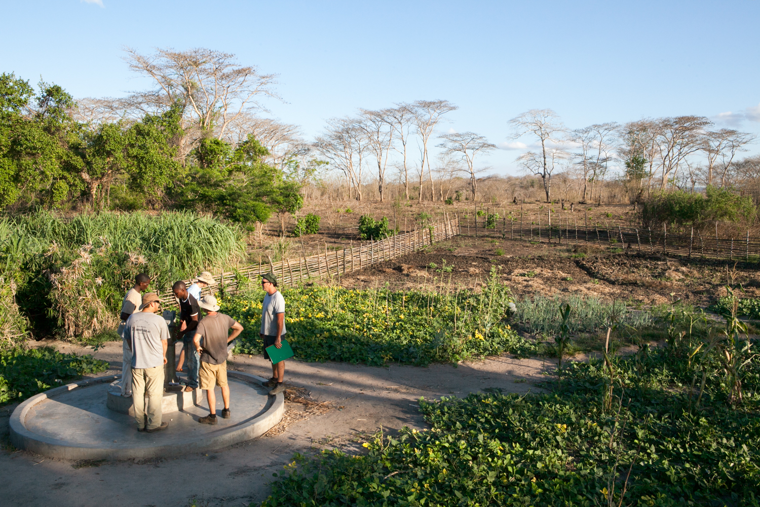 In Mozambique's remote Cabo Delgado Province, international NGO representatives visit with locals to assess water well pump operation.