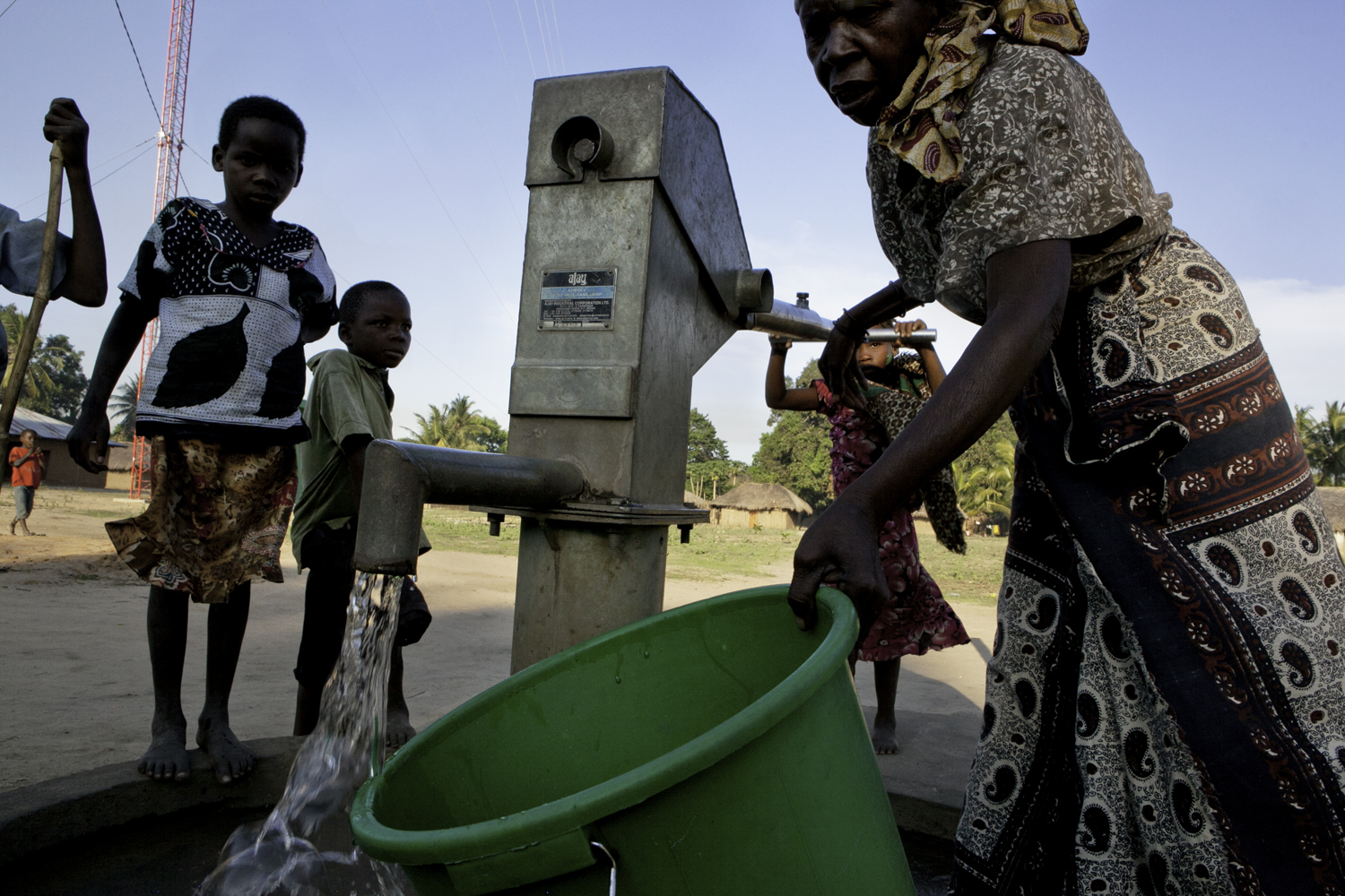  After well rehab is successful, people of all ages utilize the pump to gather water. 