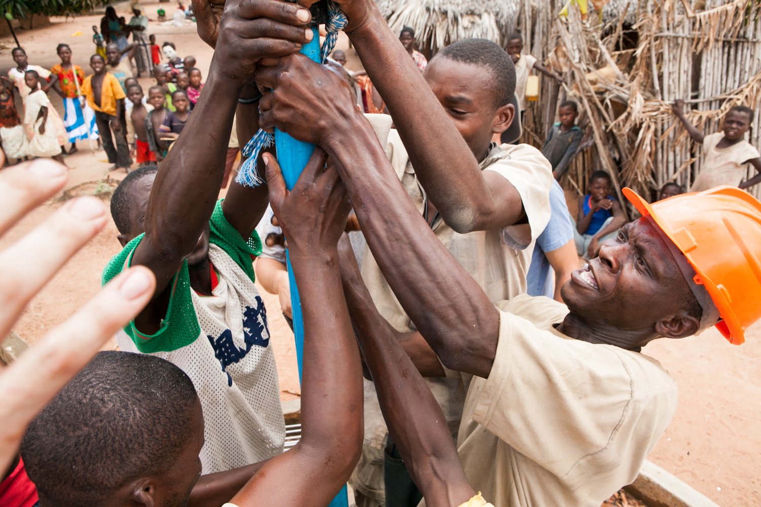  Under supervision of the NGO, locals remove the pump internals during repair activities. The NGO engages residents so they learn the well/pump mechanics, thus giving locals a sense of ownership. 