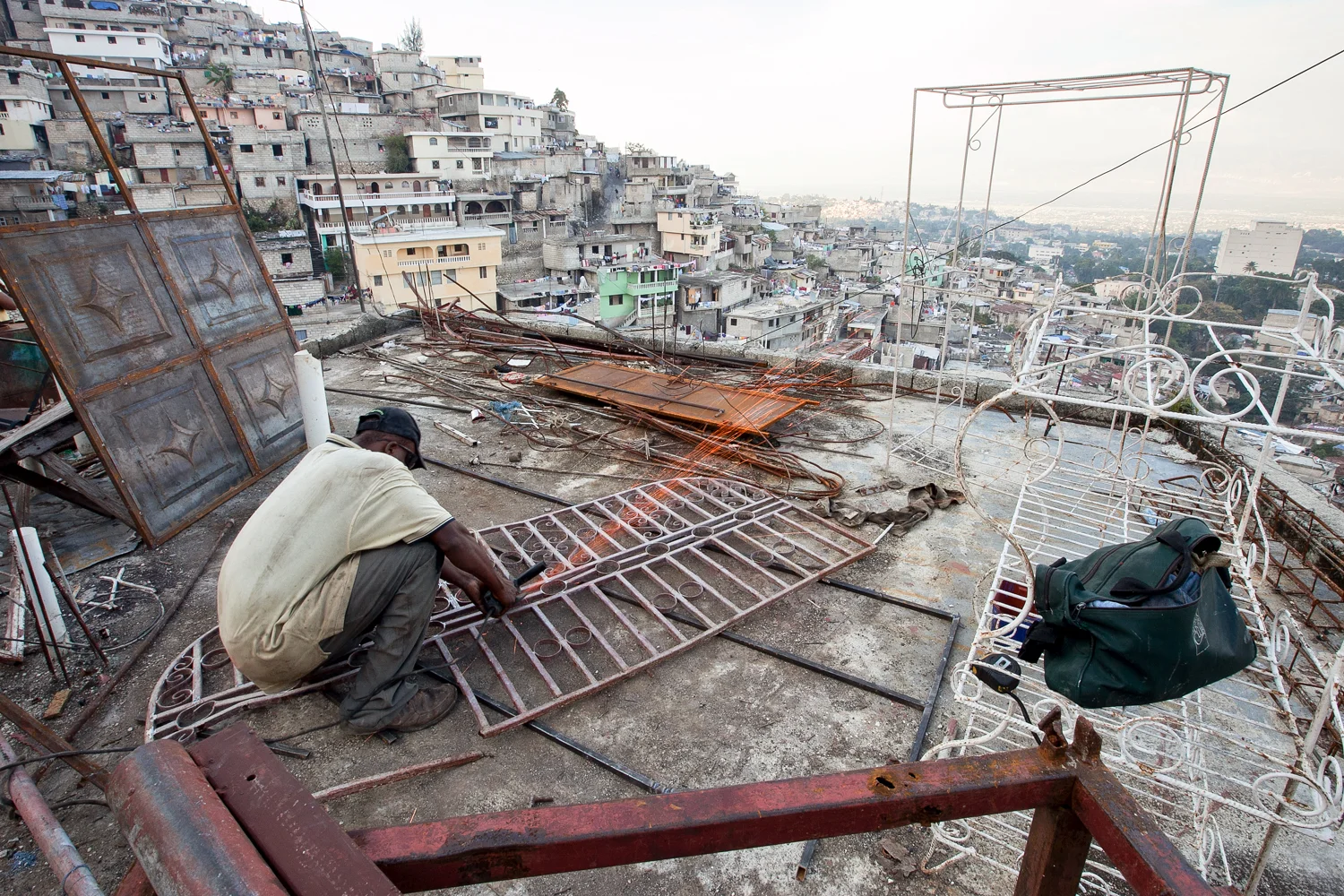 Views into overbuilt and crowded cities outside of the village act as a vivid reminder that progress remains thwarted and choked as few people attempt to rebuild and develop.