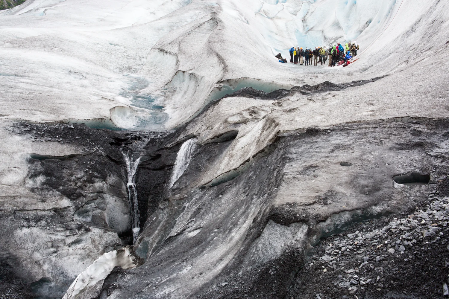 A group of high school students gather on Exit Glacier outside Seward, Alaska. The students are briefed on their upcoming ice climbing activity.
