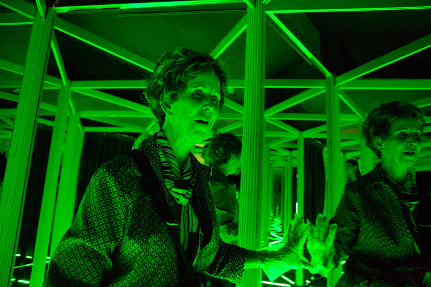 A woman walks through a mirror maze, part of the Camera Obscura and World of Illusions exhibits in Edinburgh's Old Town.