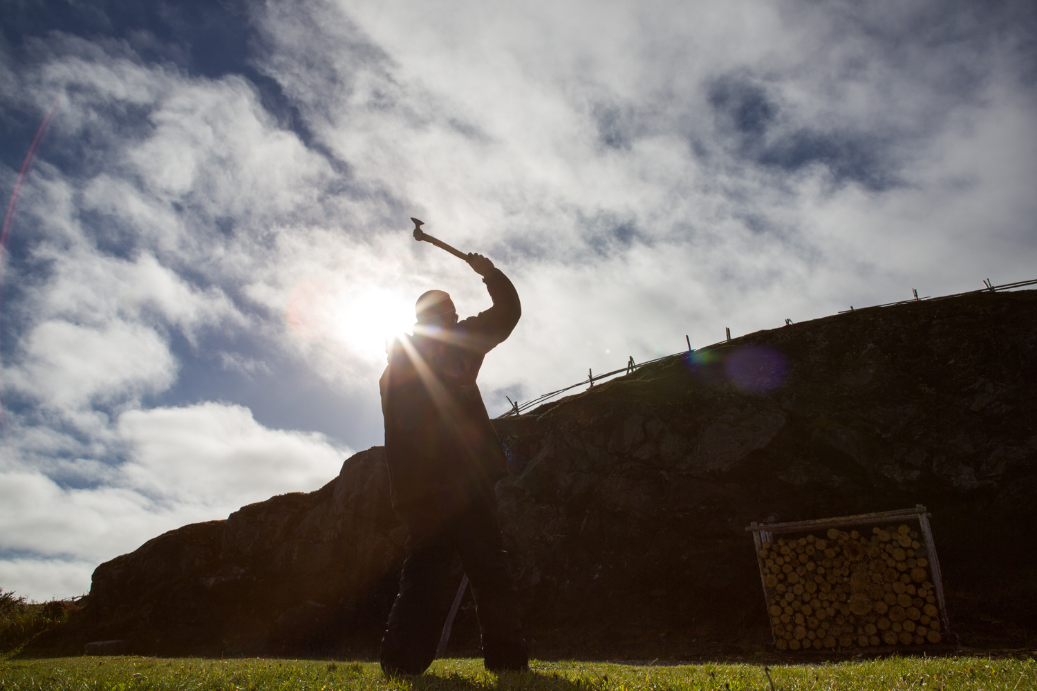  A man thows an ax toward a collection of logs at Norstead Village Village near L'Anse aux Meadows. Named a UNESCO World Heritage Site, the location is where Lief Erikson founded North America. 