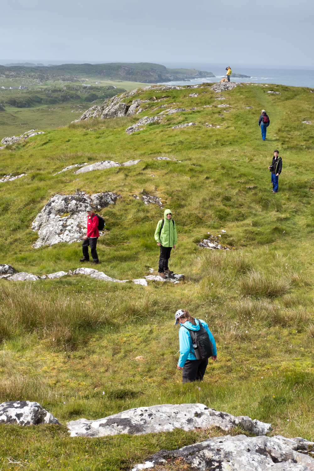  Several guests hike along a foot path on Dun I, a small hill overlooking the abbey on the island of Iona. 