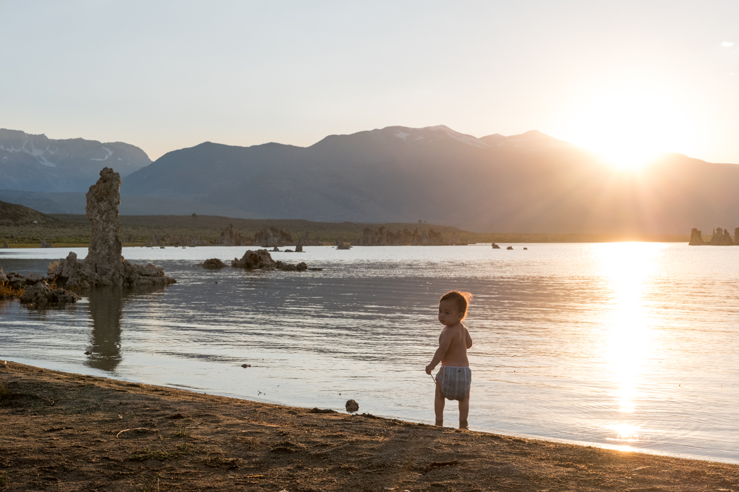  A young nature lover plays on the bank of Mono Lake at sunset. 