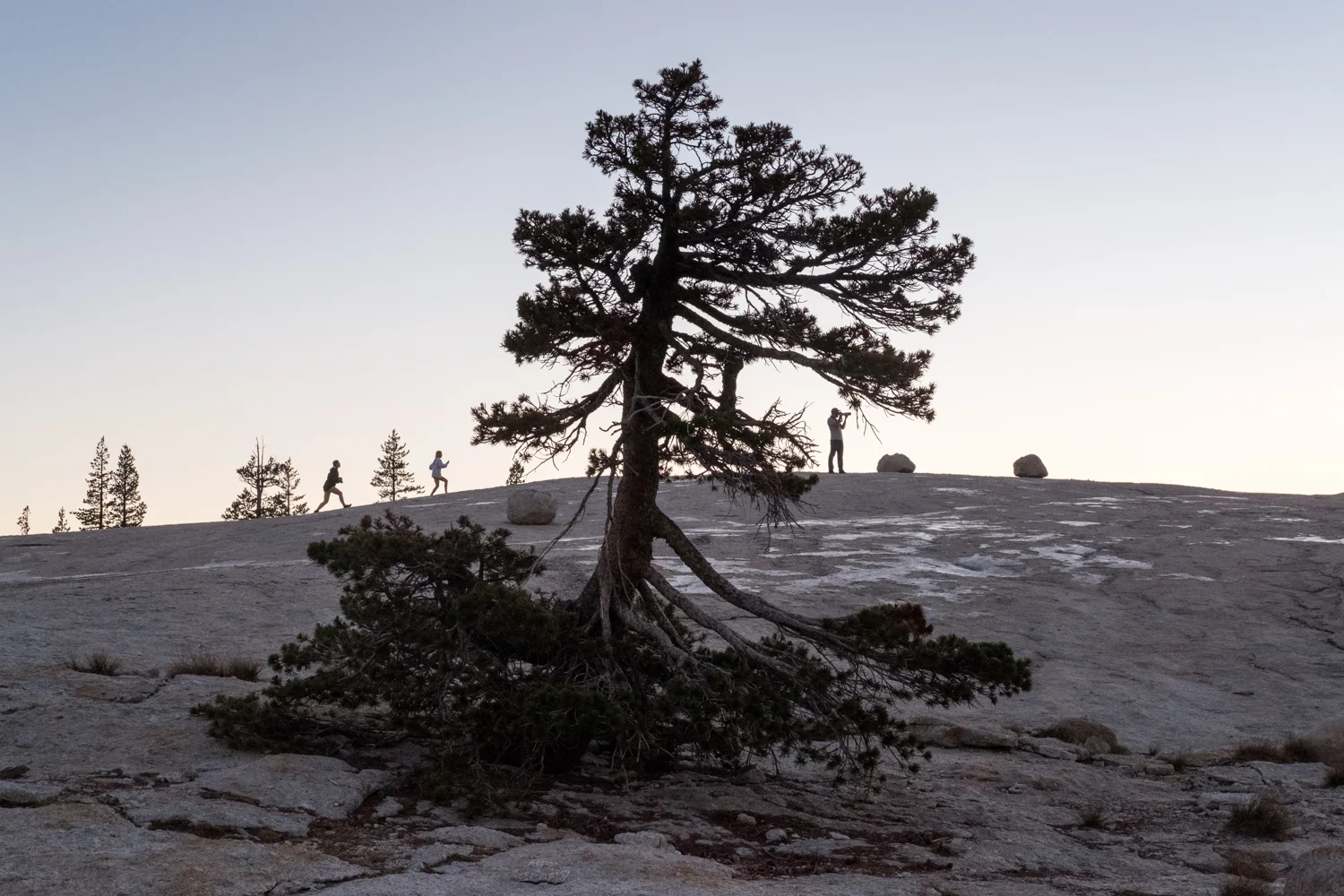 Photographers climb Pothole Dome, located on the west side of Tuolumne Meadows in Yosemite National Park.