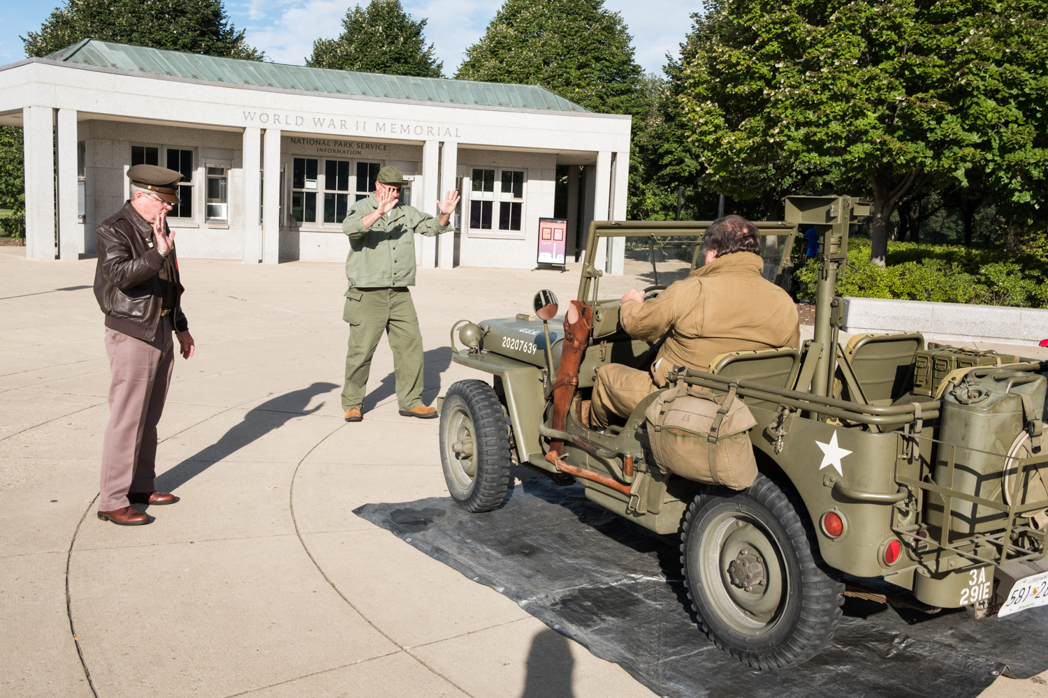 Will Snyder, a war re-enactor with the Allied Airmen's Preservation Society, parks a US Army jeep near the World War II Memorial in Washington, D.C. during an Honor Flight event. Honor Flight is when veterans from around America visit the memorials on The National Mall.