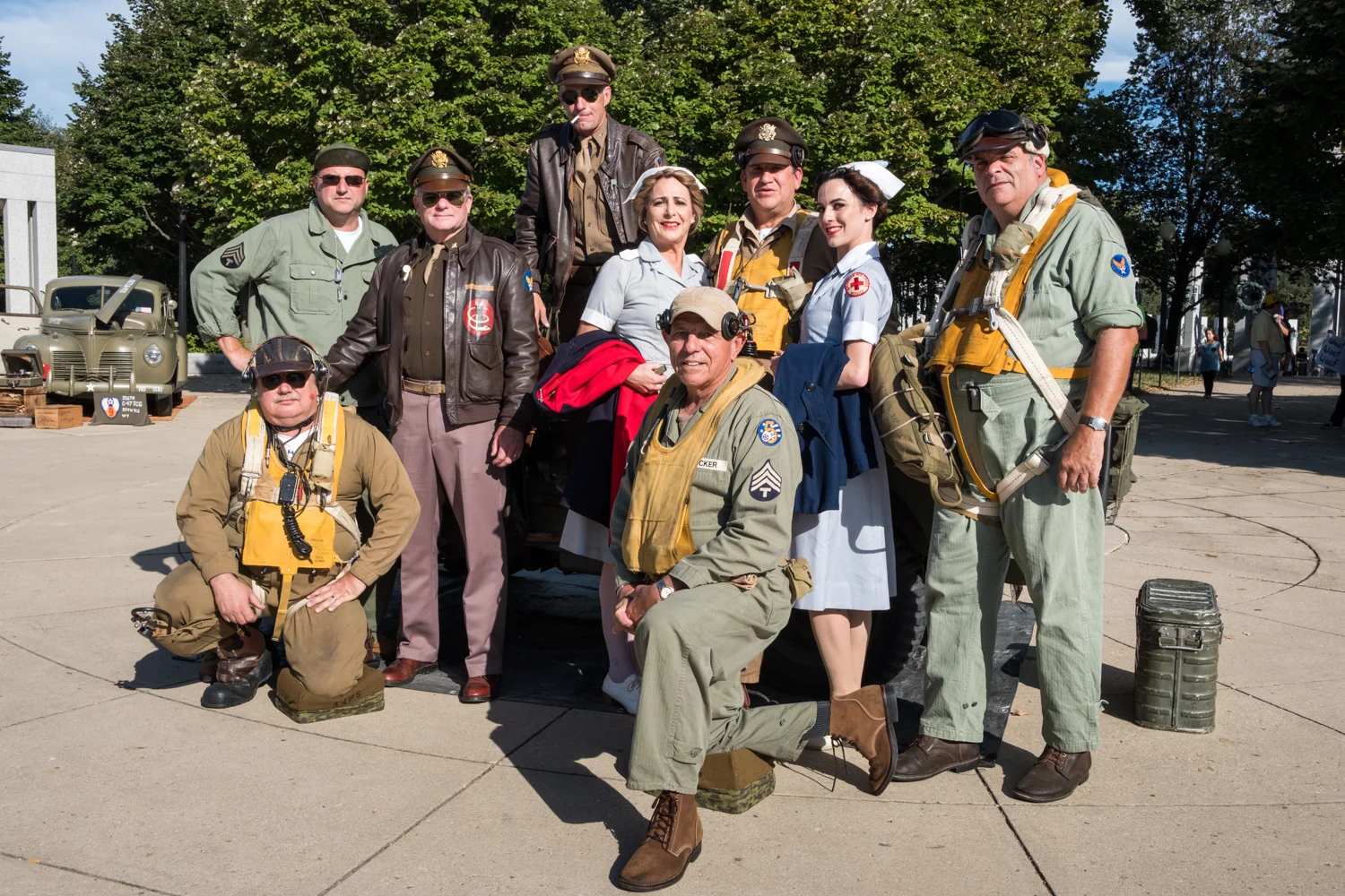 The Allied Airmen's Preservation Society poses for a portrait near the World War II Memorial in Washington, D.C. during an Honor Flight event. Honor Flight is when veterans from around America visit the memorials on The National Mall. The Allied Airmen's Preservation Society is a group of volunteers who gather during events to honor, preserve and remember veterans. Members are: Chris Gabers (standing cigarette), Standing L to R, Dave Nichols, Bill Groff, Laura Shaw, Phil Escobar, Hailey Shaw, Vance Valenzo, Kneeling L to R, Will Snyder, Joe Becker.