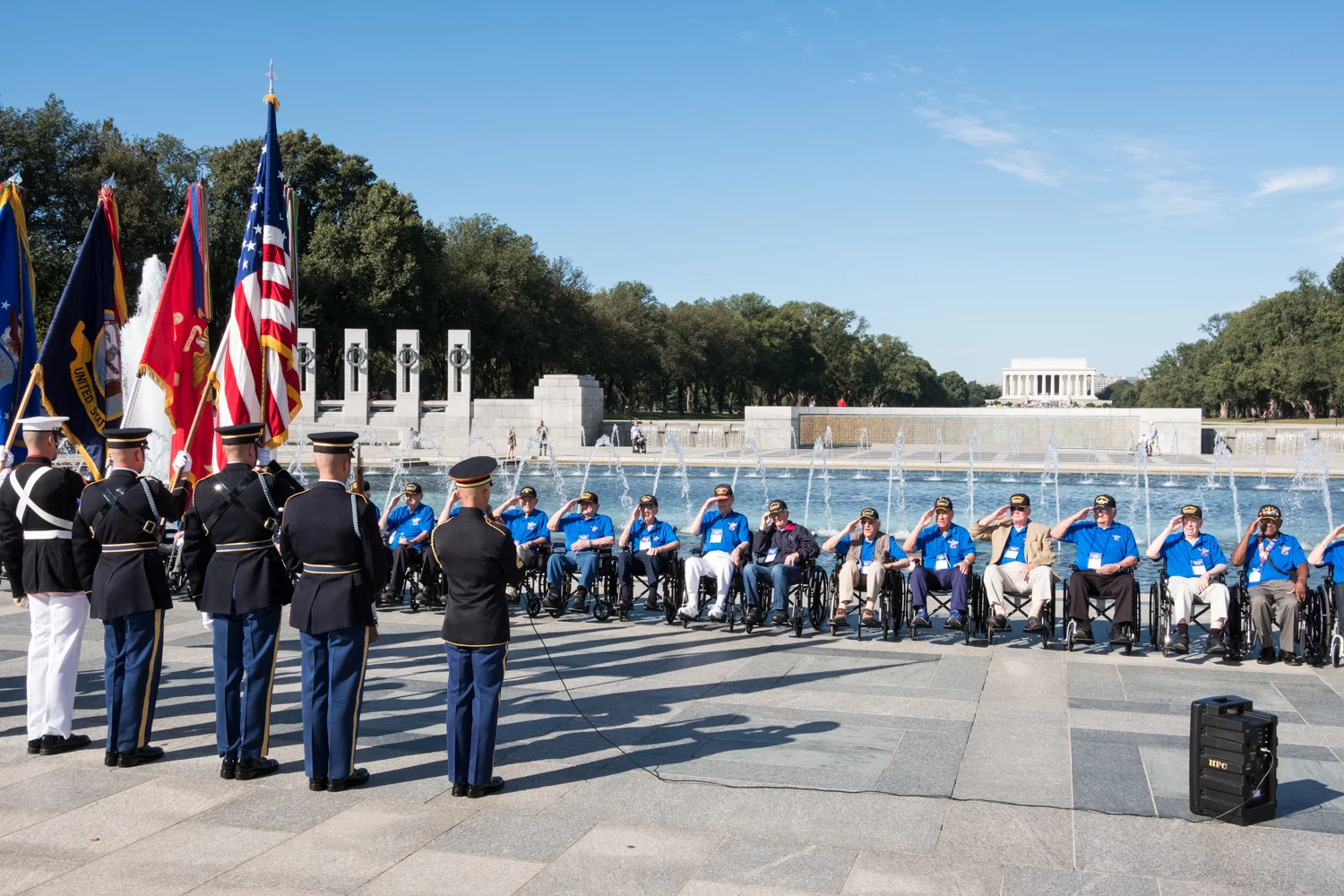 Veterans from Houston, Texas, line up at the World War II Memorial in Washington, D.C. and salute The Color Guard during an Honor Flight event. Honor Flight is when veterans from around America visit the memorials on The National Mall.