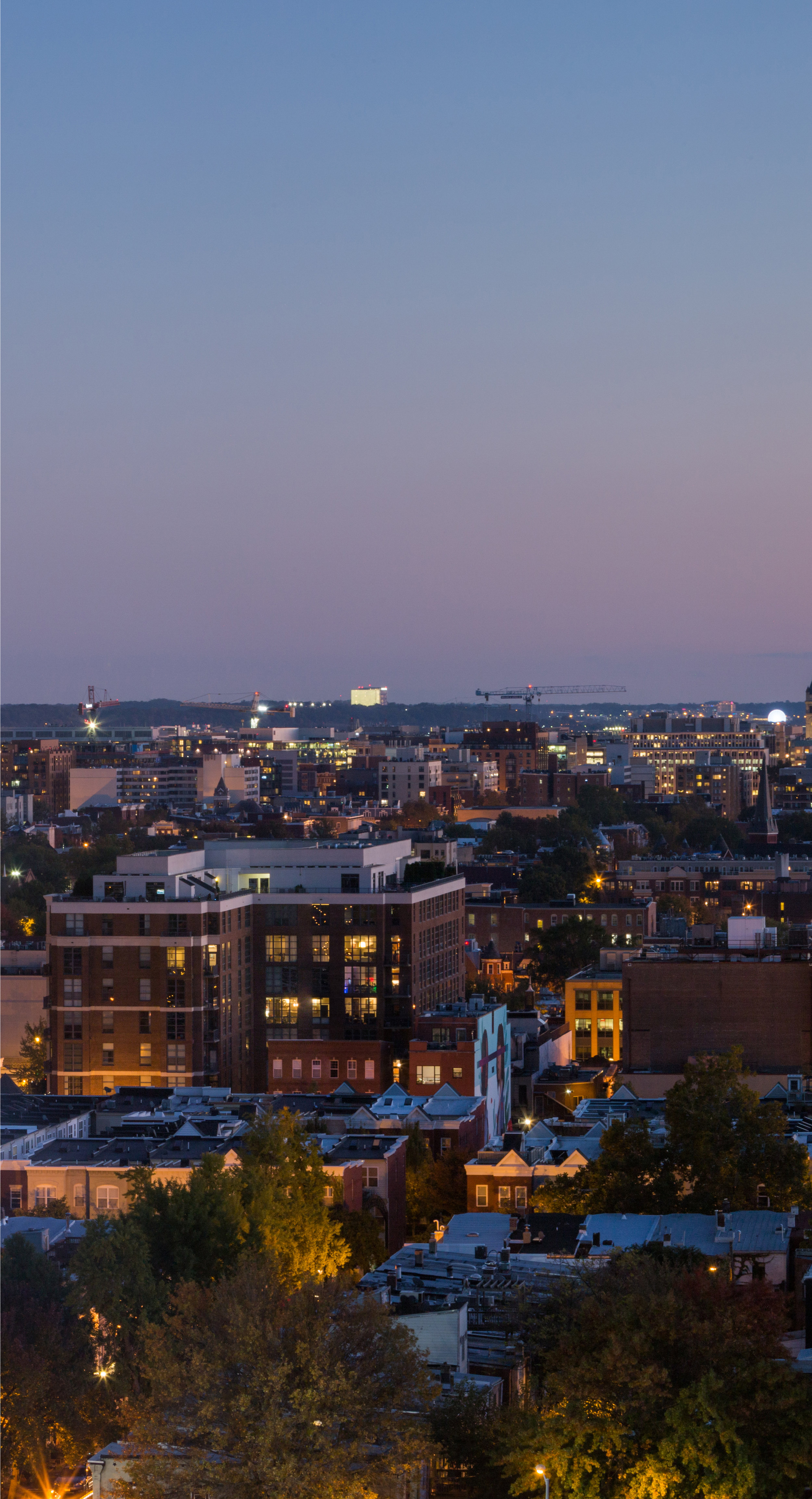Eric Kruszewski photographs a panorama landscape of the Washington, D.C. skyline at sunset.