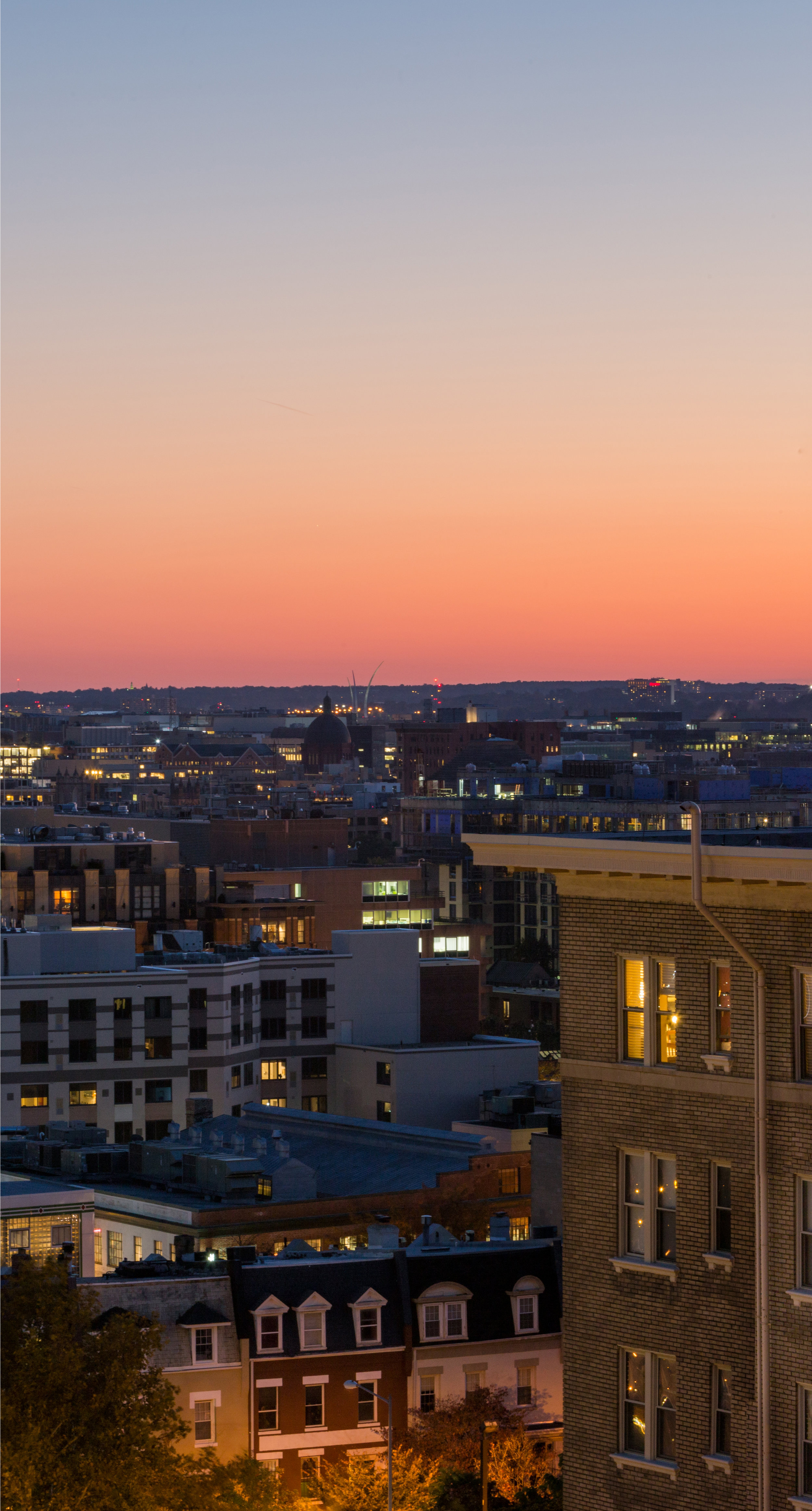 Eric Kruszewski photographs a panorama landscape of the Washington, D.C. skyline at sunset.