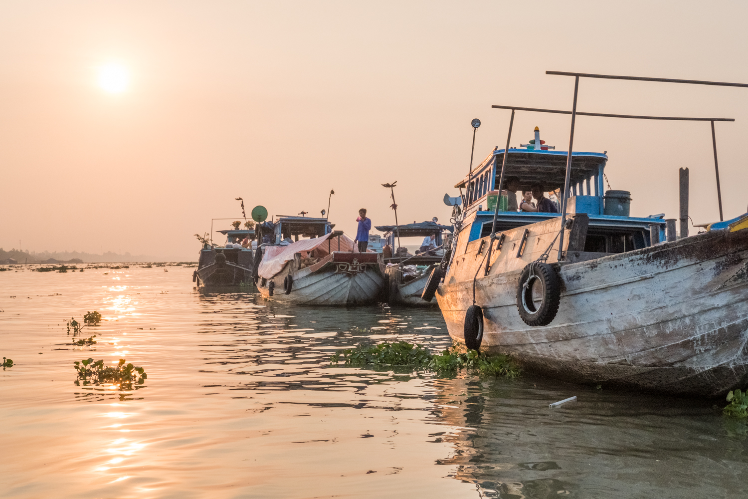  In Chau Doc, Vietnam, boats line up at sunrise to prepare for selling goods at the floating market. 