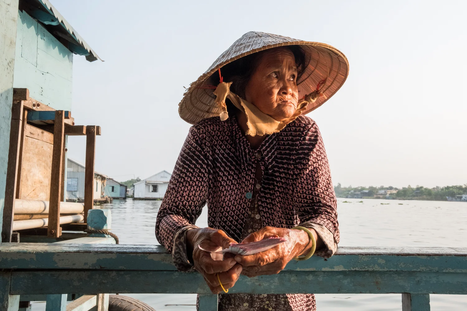 Chau Doc, Vietnam is one of the best places to see villages comprised of floating houses and fish farms. While visiting one of the houses, this woman approached in her boat and asked if I’d like to buy lottery tickets.