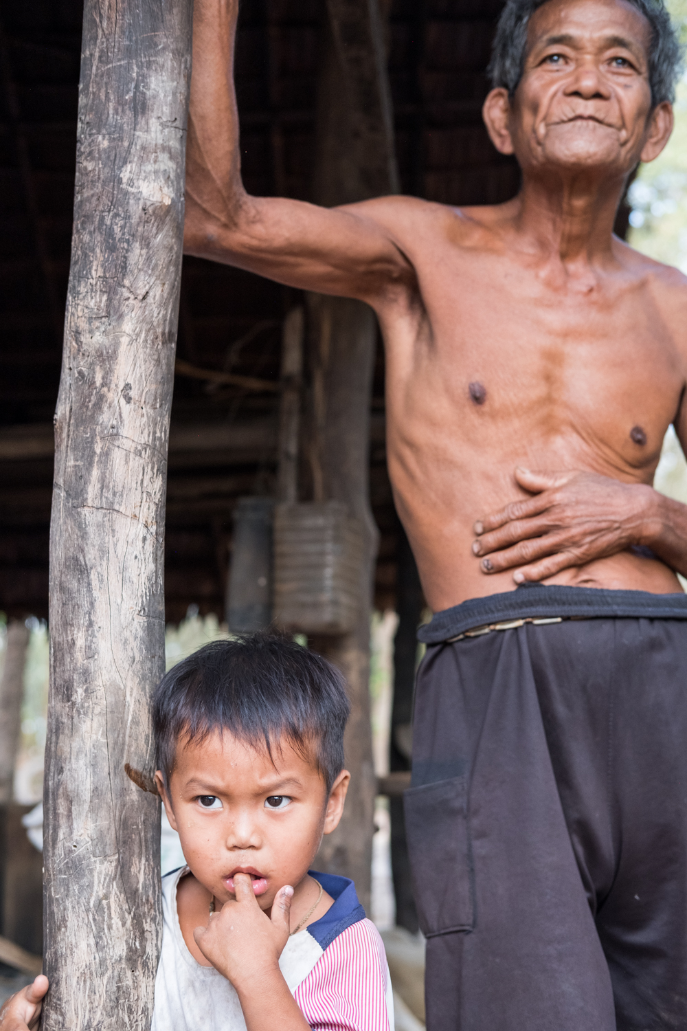  An uncle and his nephew pause next to a structure in Kampong Chhnang, Cambodia. 