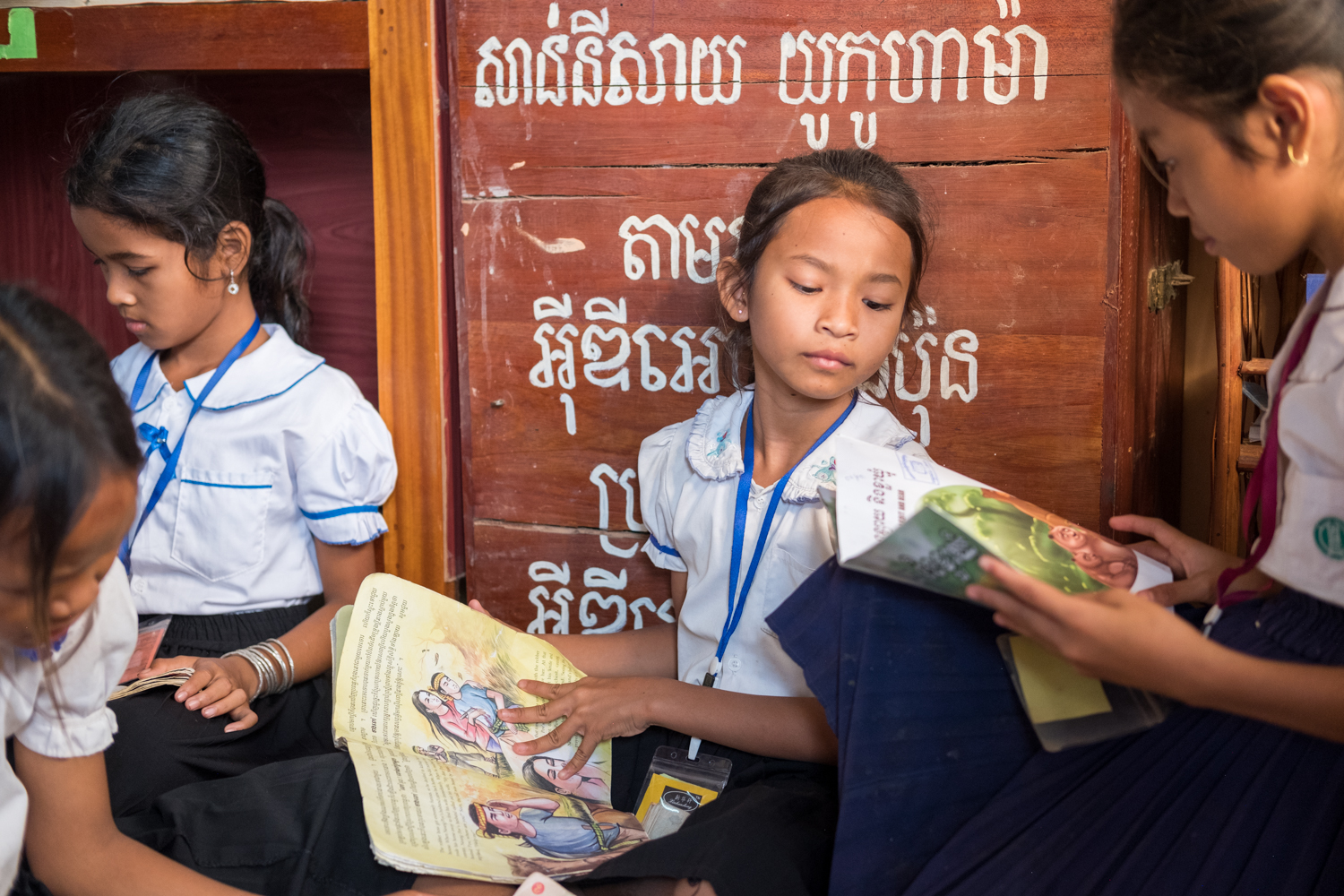  Several girls read books inside the library of a local grammar school in the village of Kampong Tralach, Cambodia. 