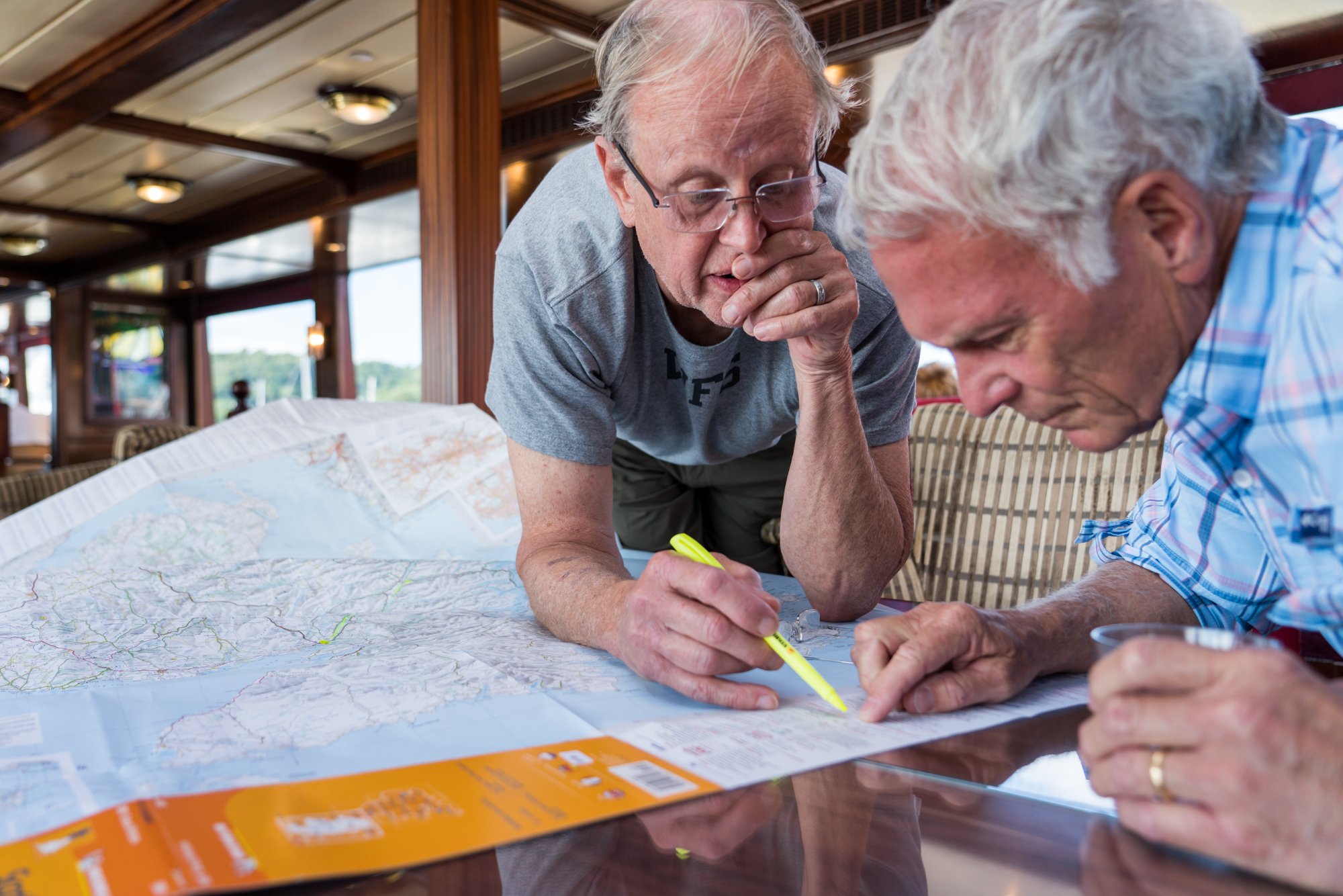  Two guests study the legend on a Scotland map while aboard Lord of the Glens. 