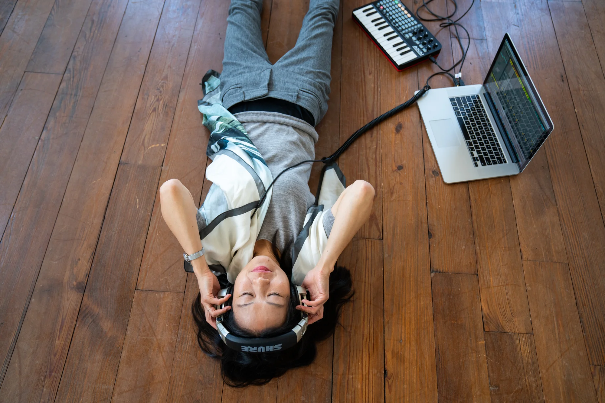 In Washington, D.C.’s Halcyon House, Yoko K. Sen demonstrates how she relaxes and focuses on sound while laying down, thus mimicking a patient in a hospital bed.