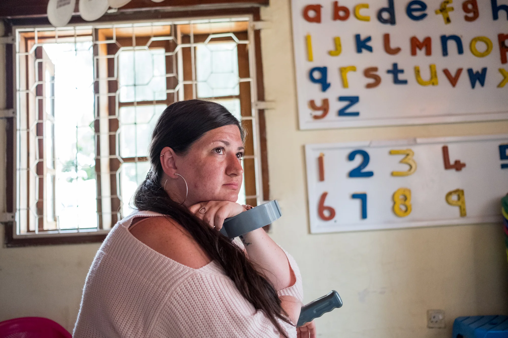 Holly poses for a portrait inside a classroom at Child Support Tanzania, a non-governmental organization located in Mbeya, Tanzania, that educates disabled children.