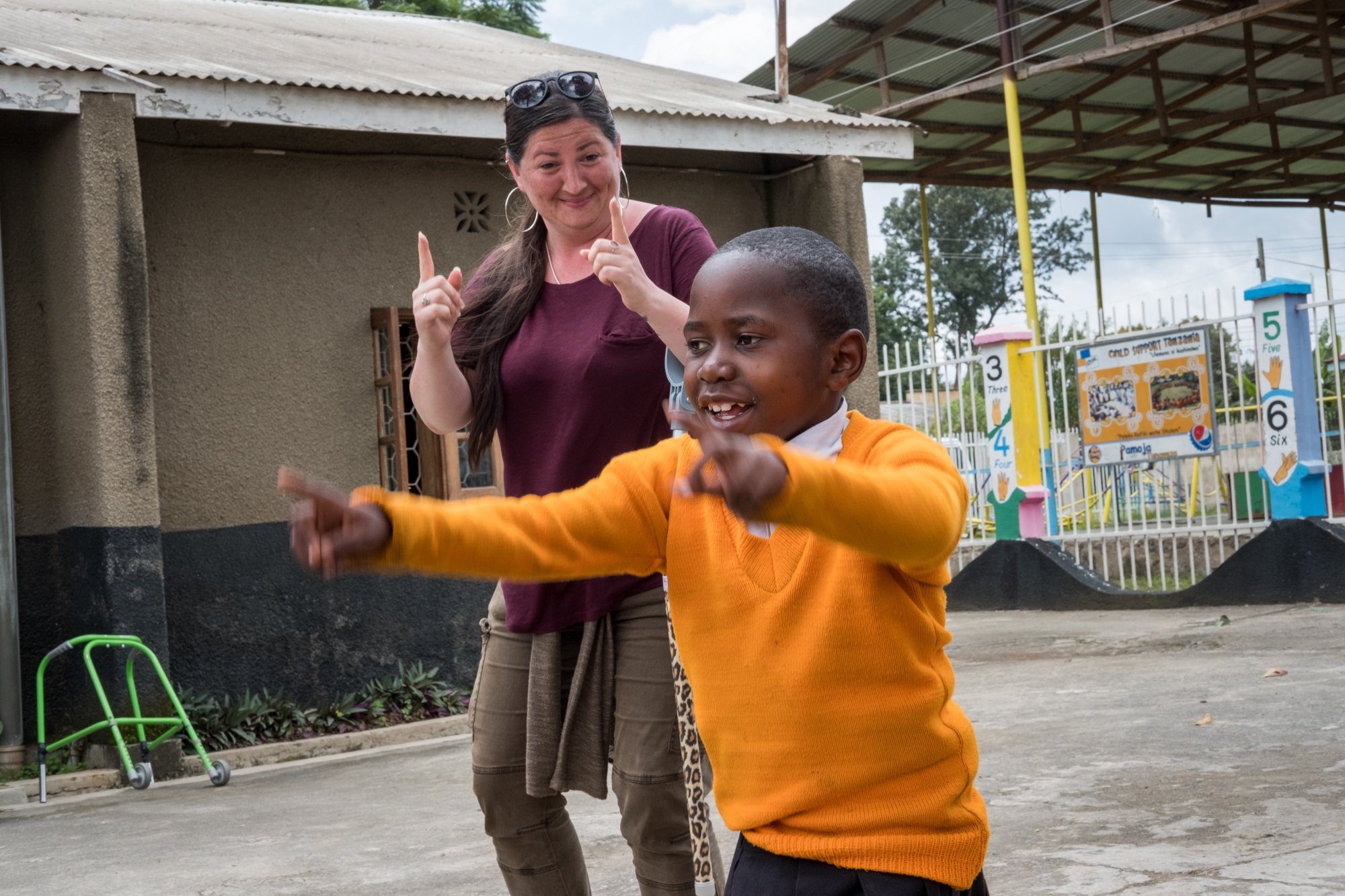  Holly dances alongside a student at Child Support Tanzania. Each day, students have the opportunity to play outside, socialize and listen to music. 