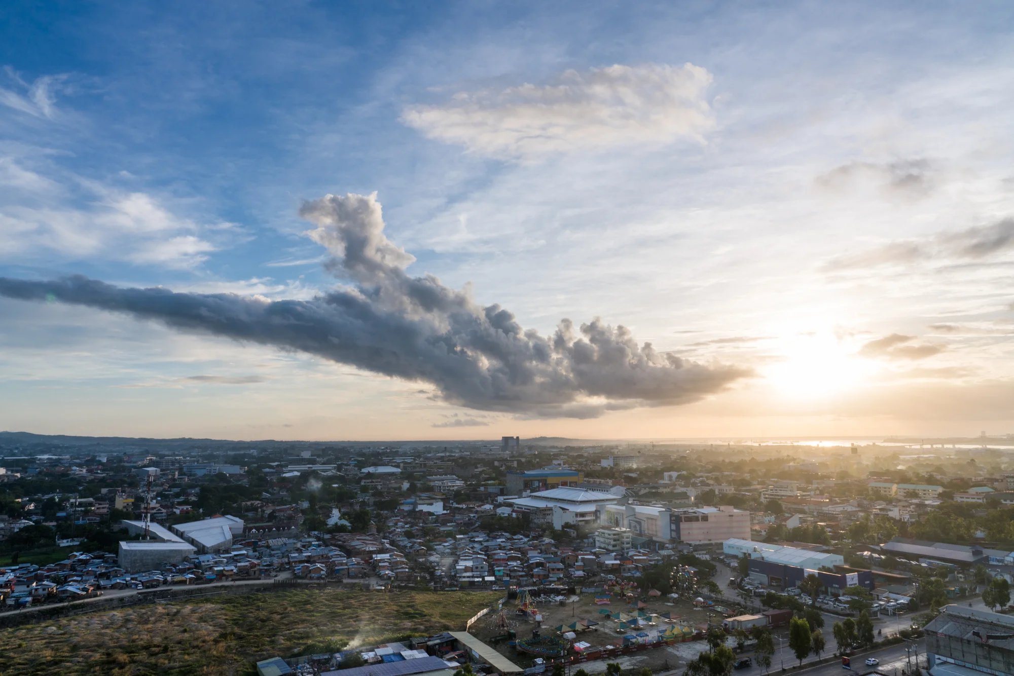 Clouds partially cover the sun as it rises above Cebu City, Philippines. Frank Becker, a Hilton Team Member and Thrive Sabbatical winner, established a local program to help children in Cebu, who usually survive off trash dumps, by offering school supplies and nutritious meal programs.
