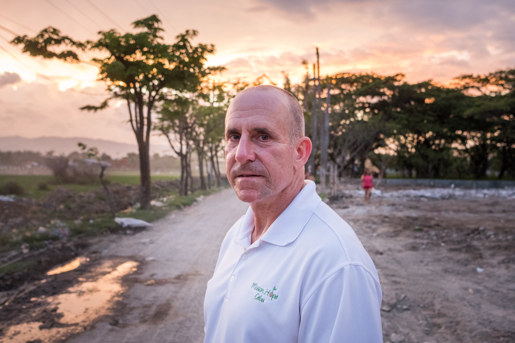  Frank Becker, a Hilton Team Member and Thrive Sabbatical winner, poses for a portrait on a road leading to the Mandaue Dump Site in Cebu, Philippines. Frank uses his personal vacation and savings to make a difference in this community. 