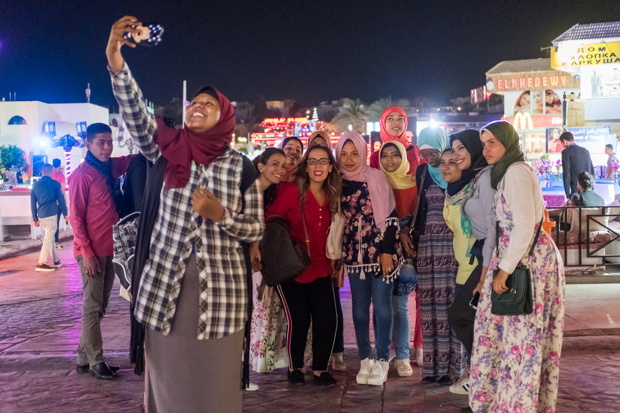  Ingy Helal (center in red) joins the initial group of 15 participant trainees for an outing at Naama Bay Night Market. 