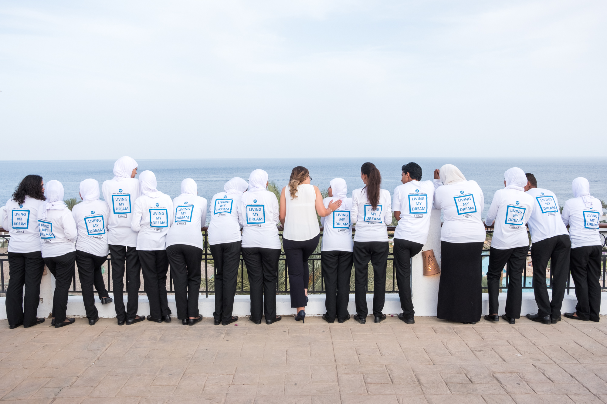 After holding a ceremony to honor the training program participants, Ingy and the original 15 training participants pose for a portrait at the resort near the Red Sea.