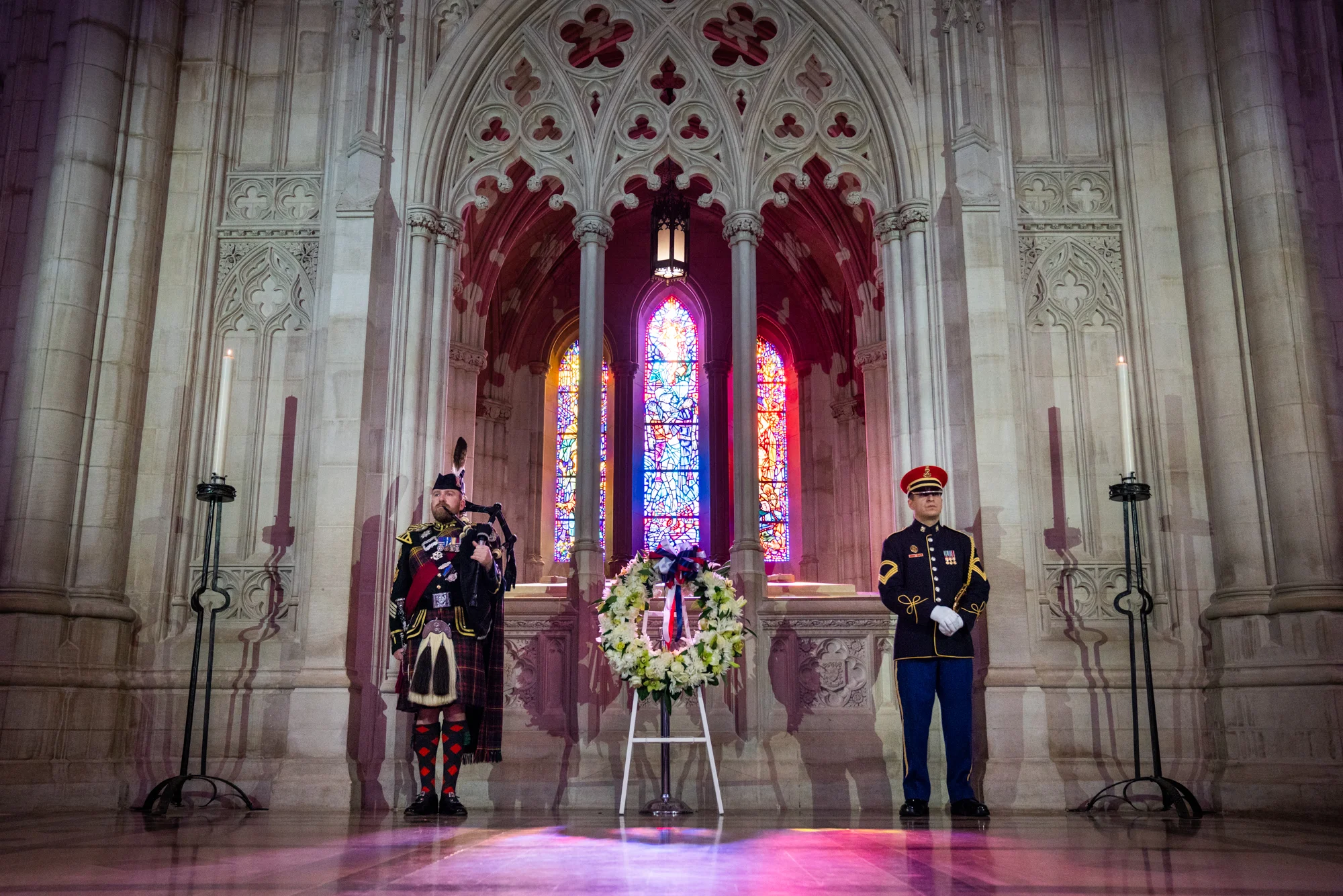 Peter MacGregor (left), Warrant Officer Class 2 Pipe Major, and a member of the U.S. Army Band (right) stand at attention alongside the centennial wreath.