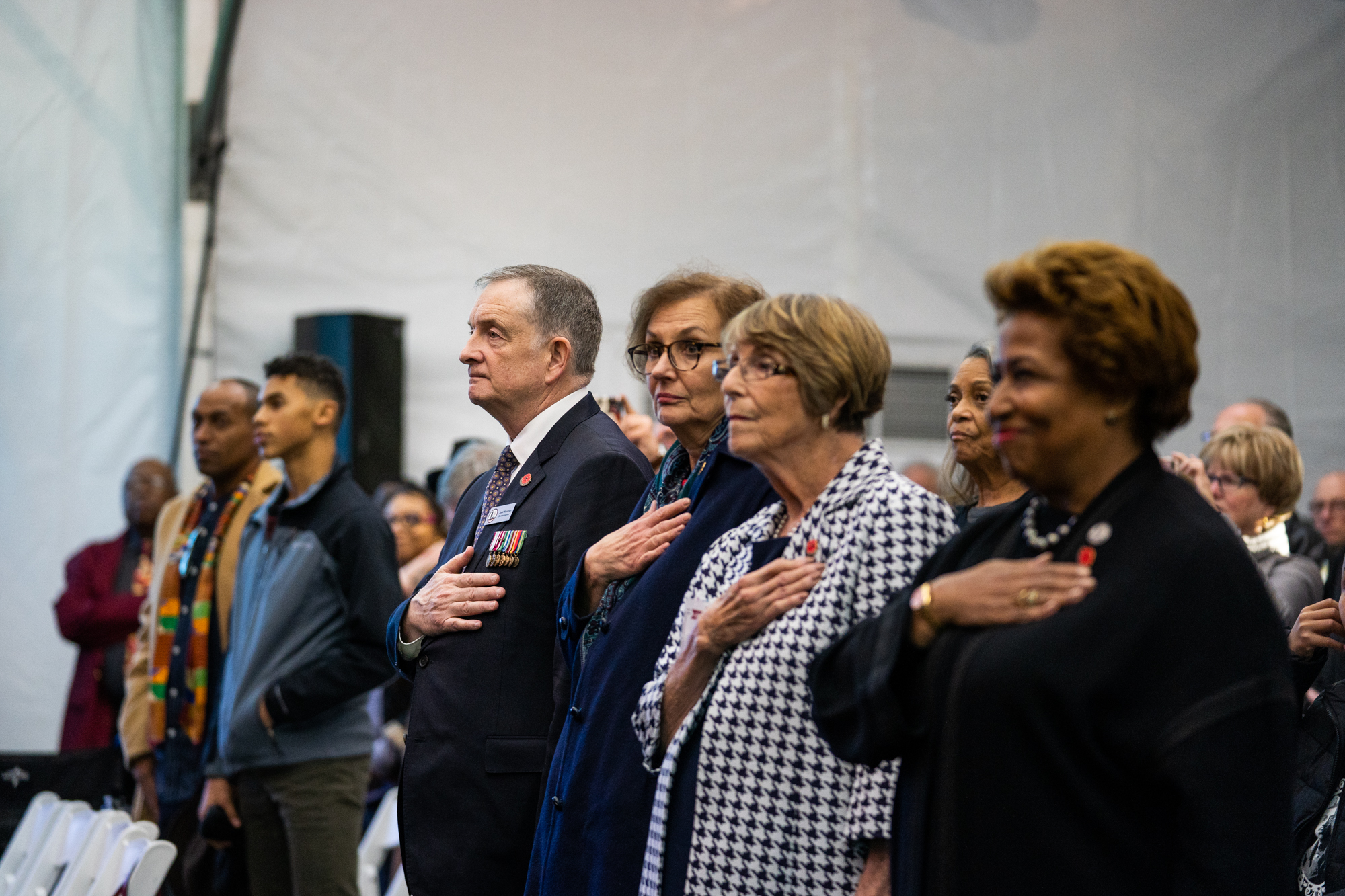  During a musical performance by the 369th Experience Band, attendees, including John Monahan, Commissioner and American Legion Representative, WWI Centennial Commission, stand at attention. 